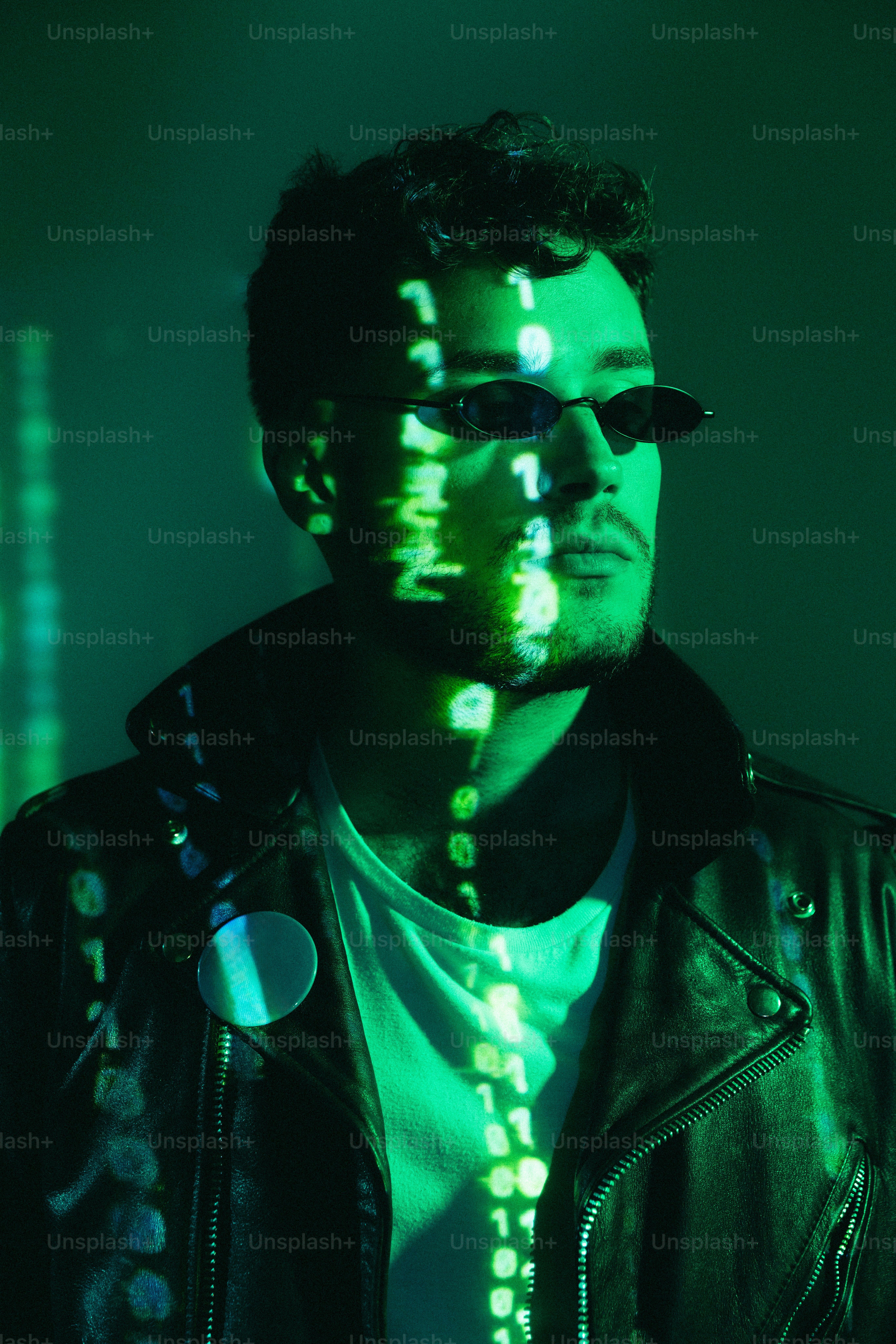 A man wearing a leather jacket and sunglasses