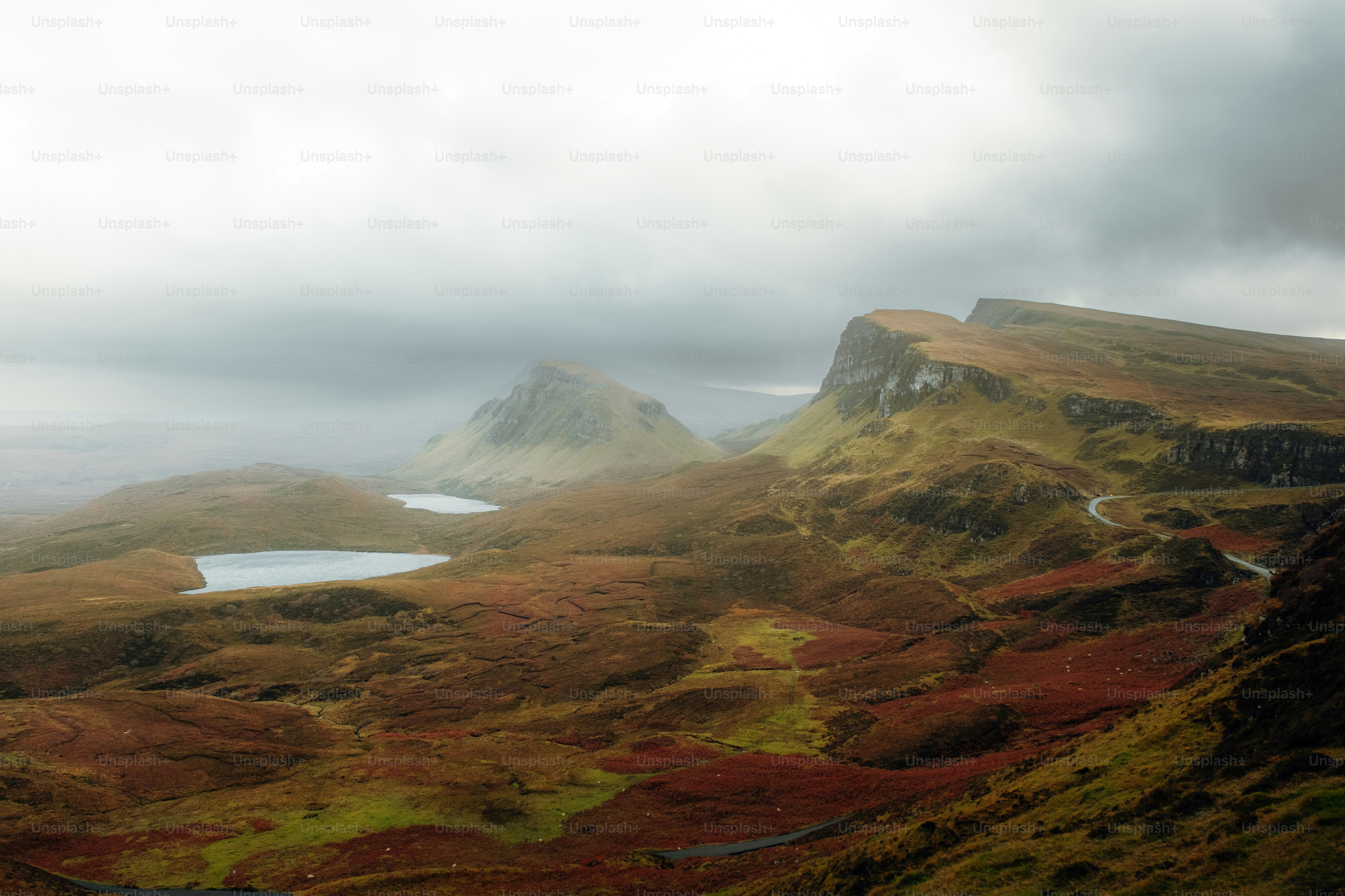 A scenic view of a mountain range with a lake in the foreground