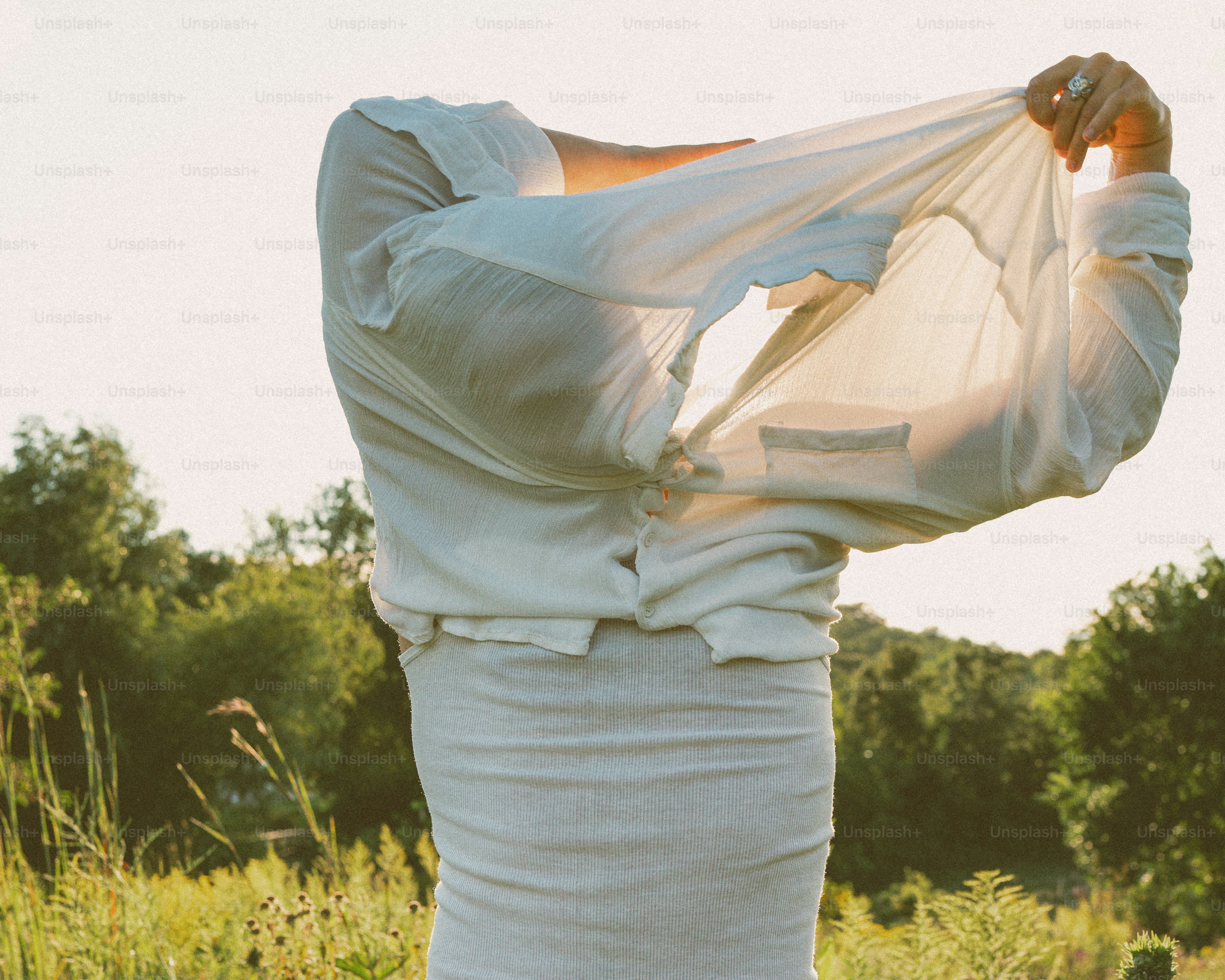 A woman in a white dress standing in a field
