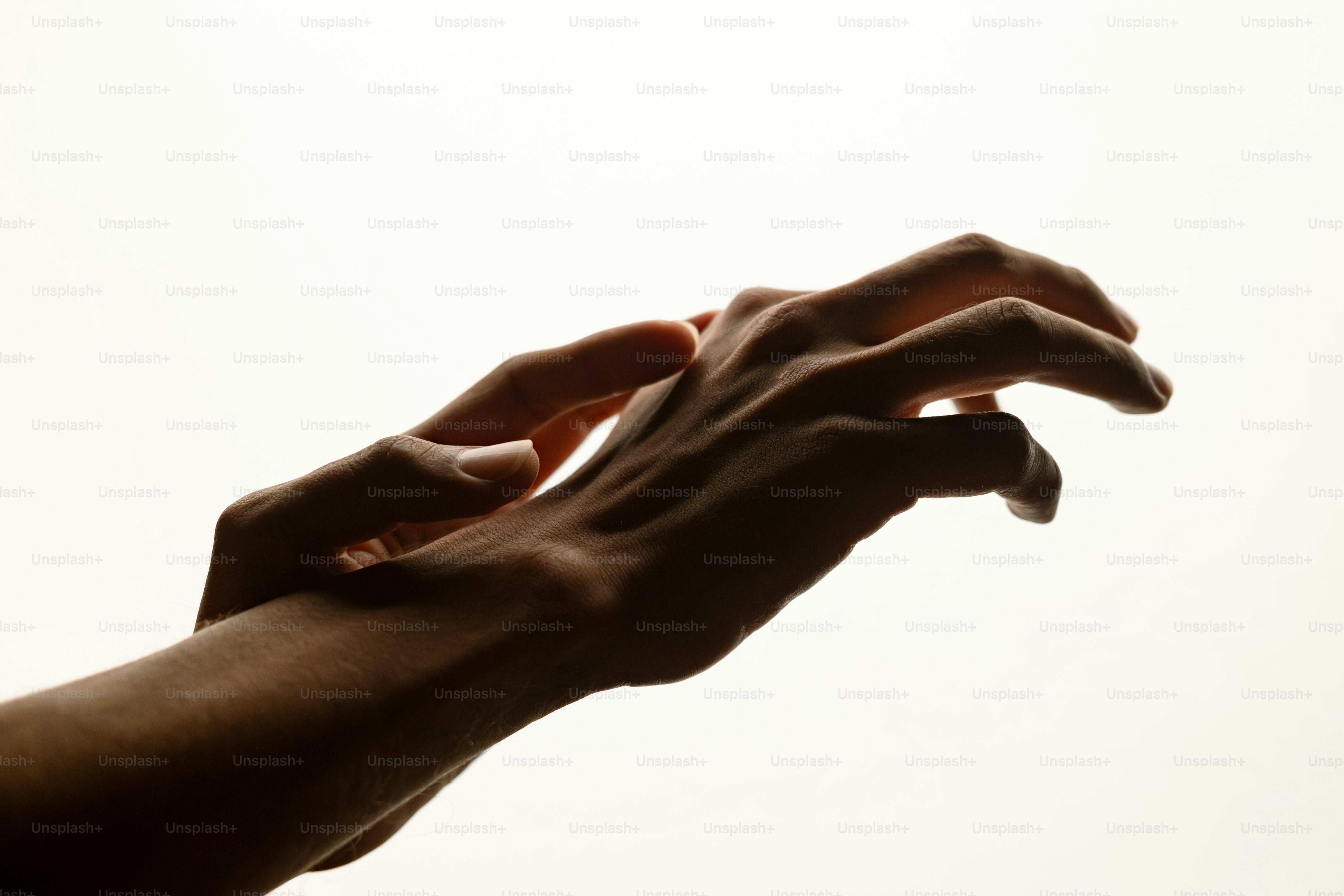 Two hands reaching towards each other in the air