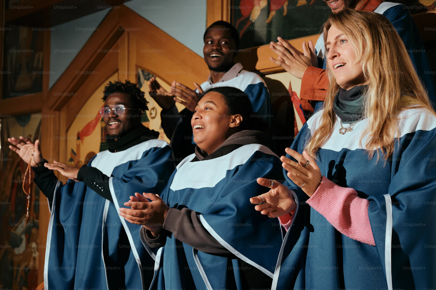 Gospel choir singing with their conductor in church