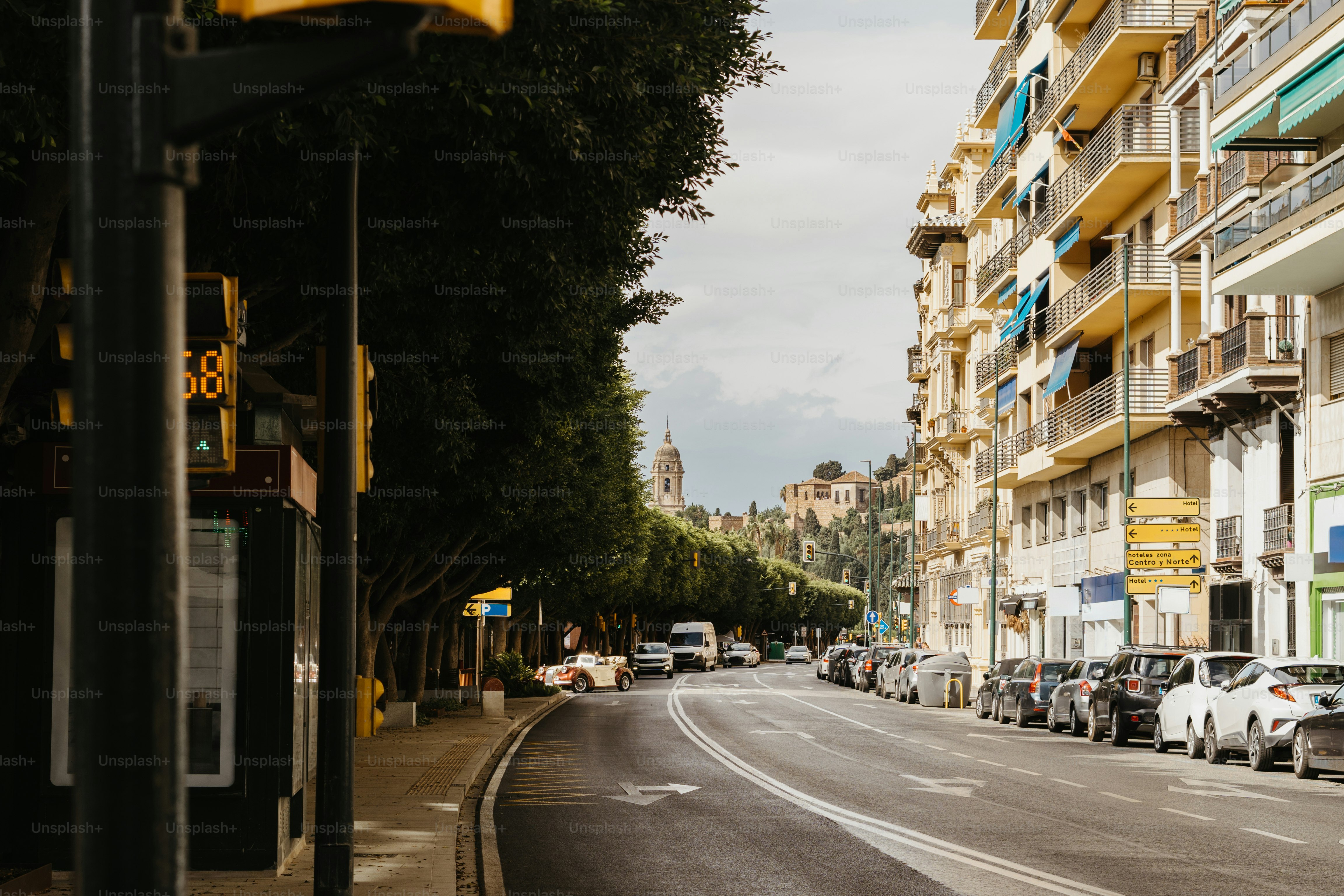 A yellow traffic light sitting on the side of a road
