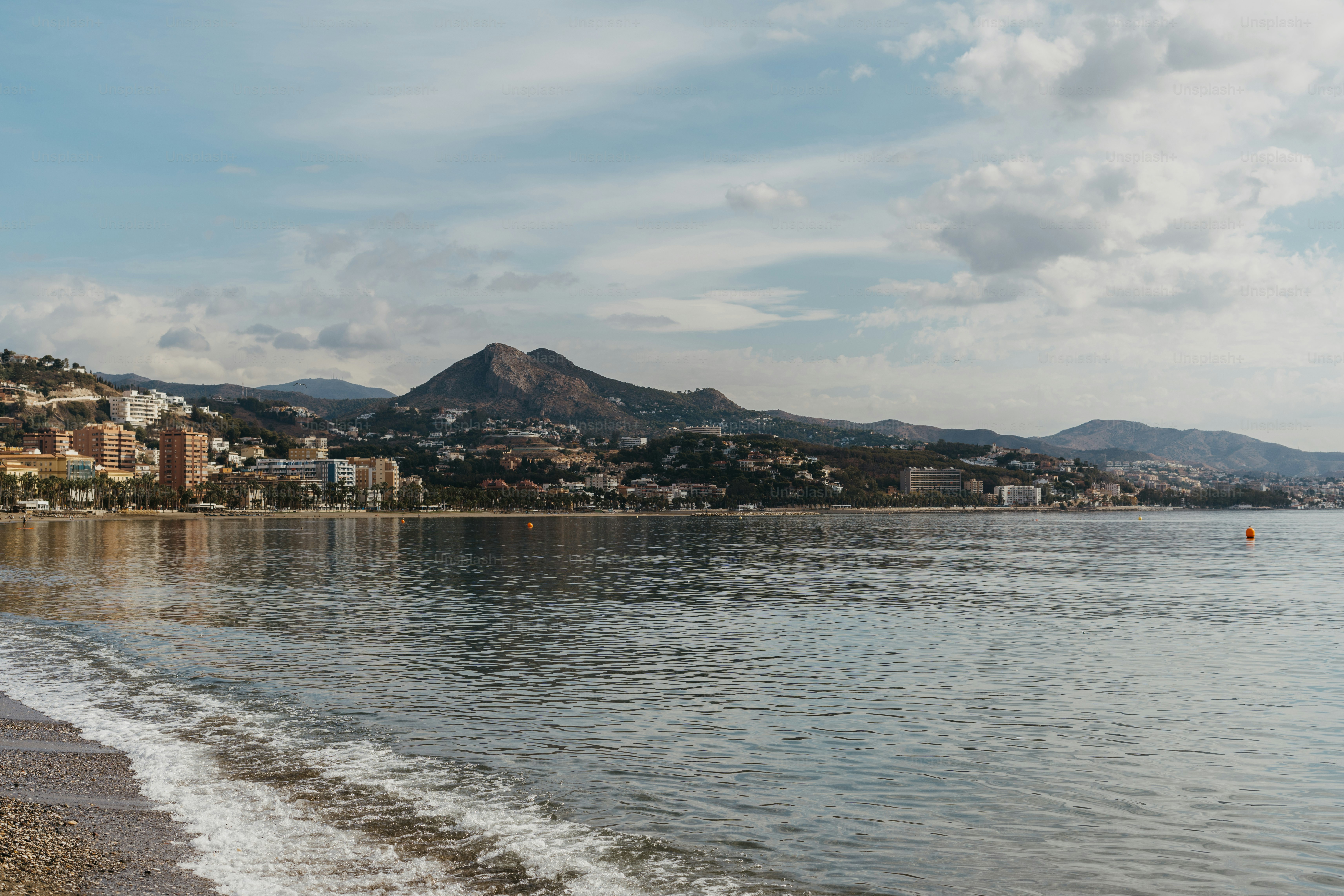 A body of water with a city in the background