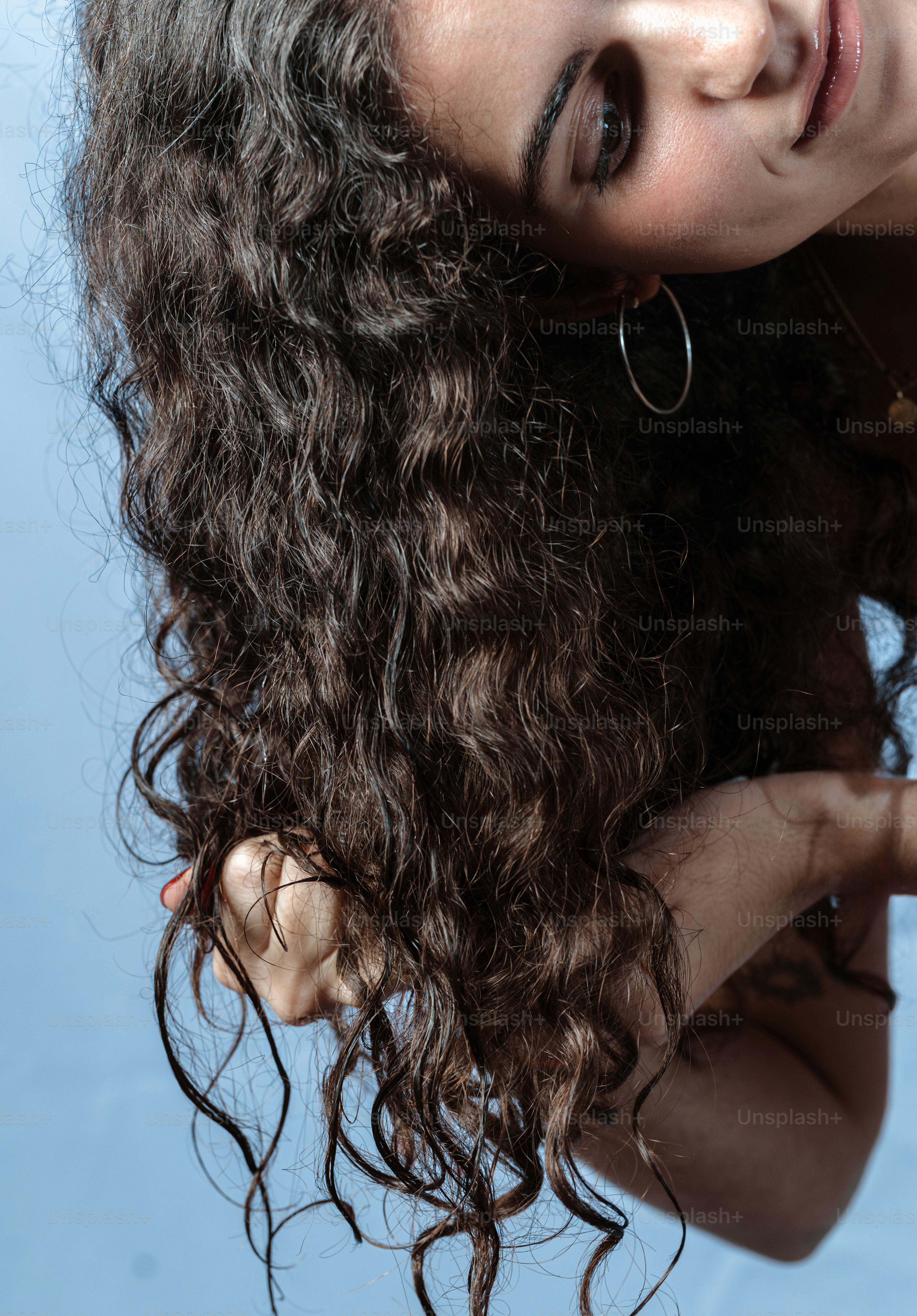Una mujer con el pelo rizado posando para una foto