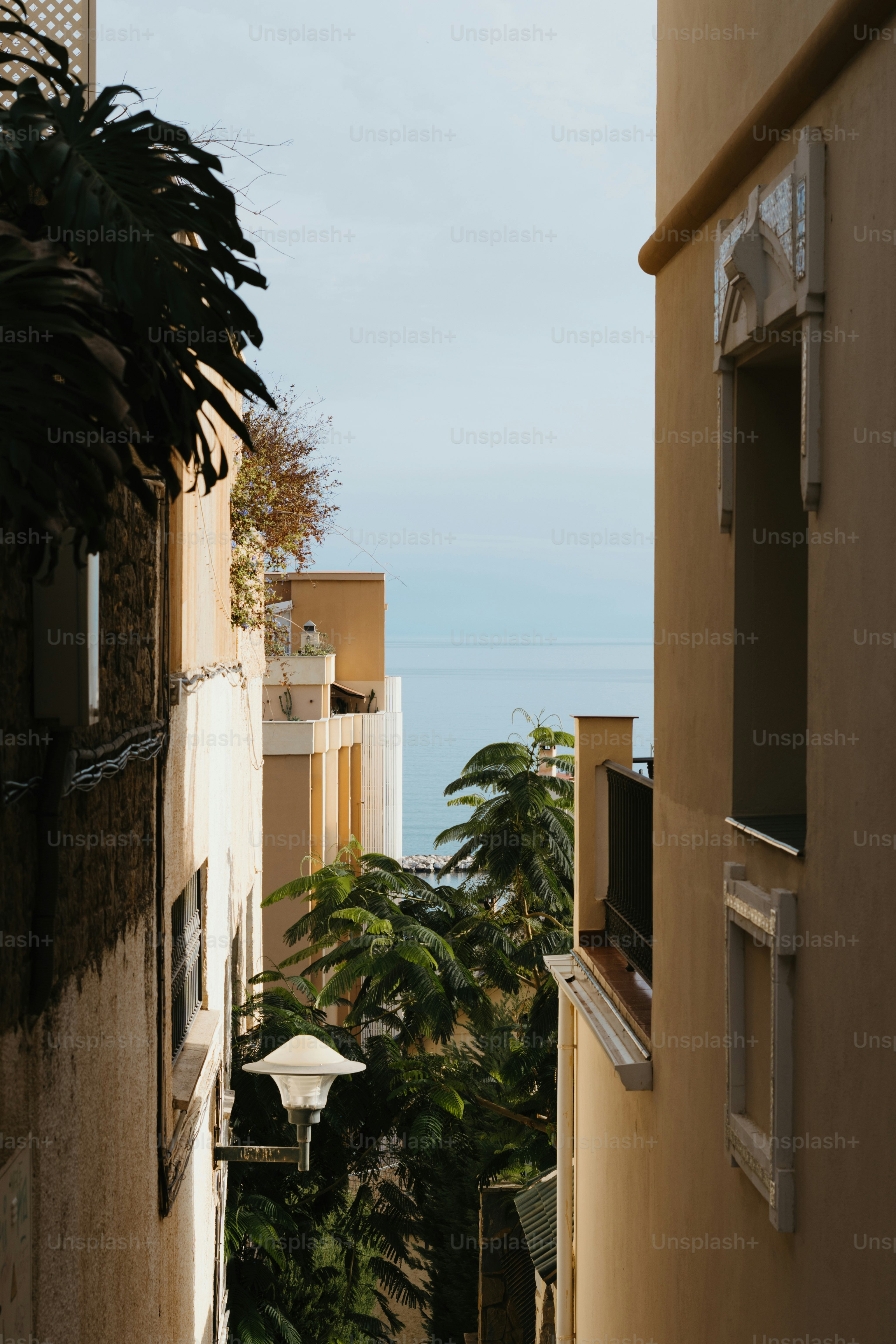 A narrow alley way with a view of the ocean
