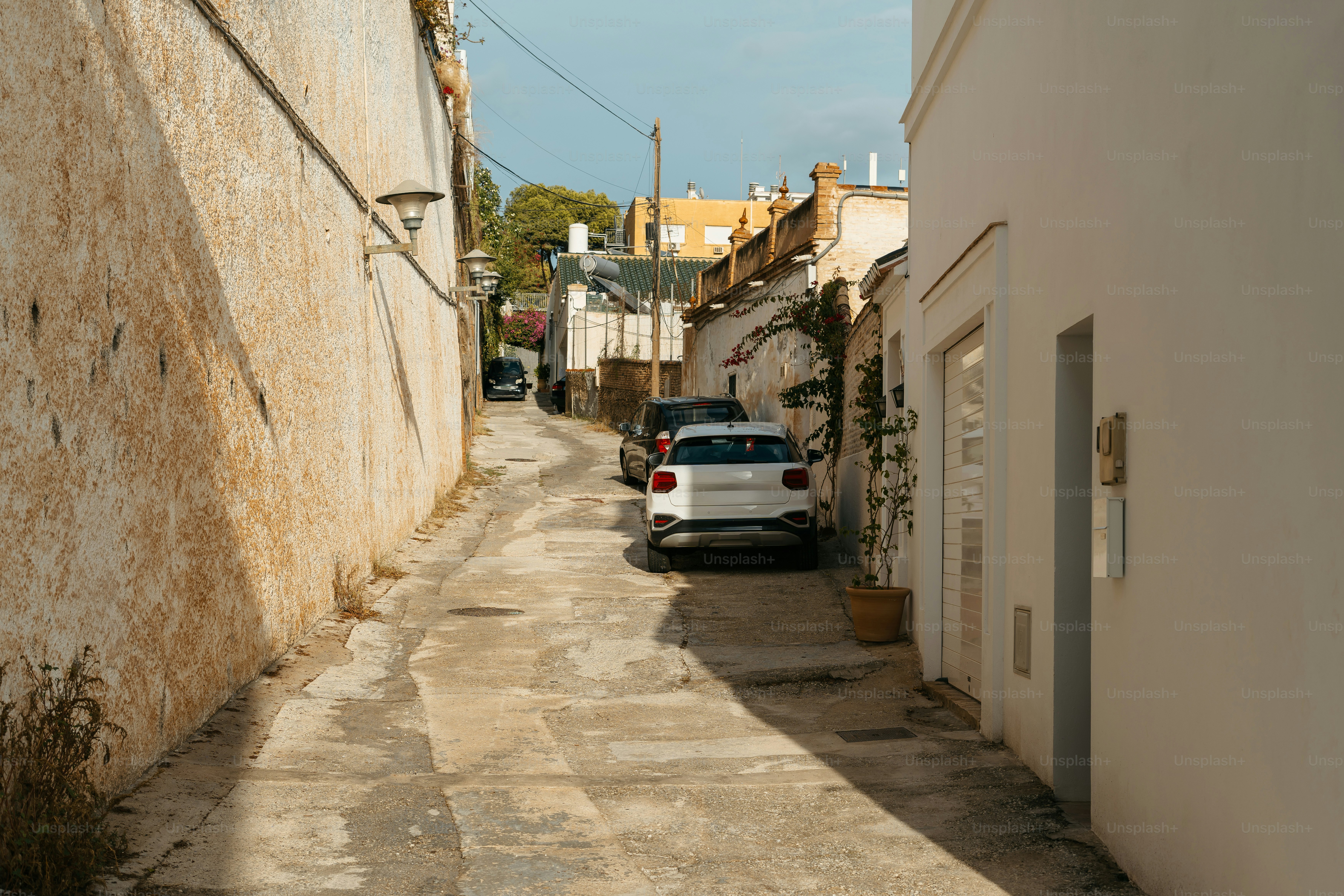 A car parked on the side of a road next to a building