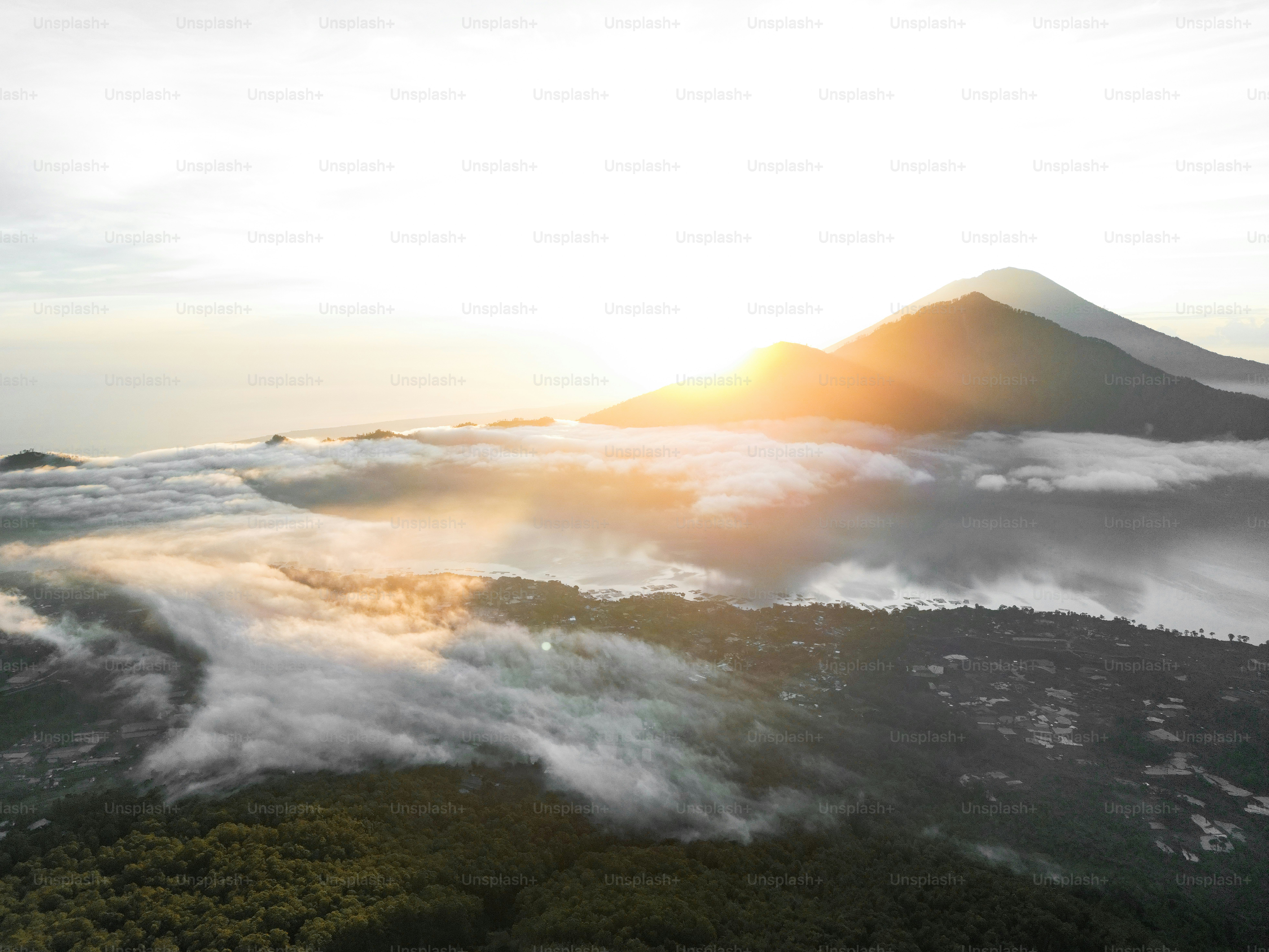 A view of the top of a mountain covered in clouds