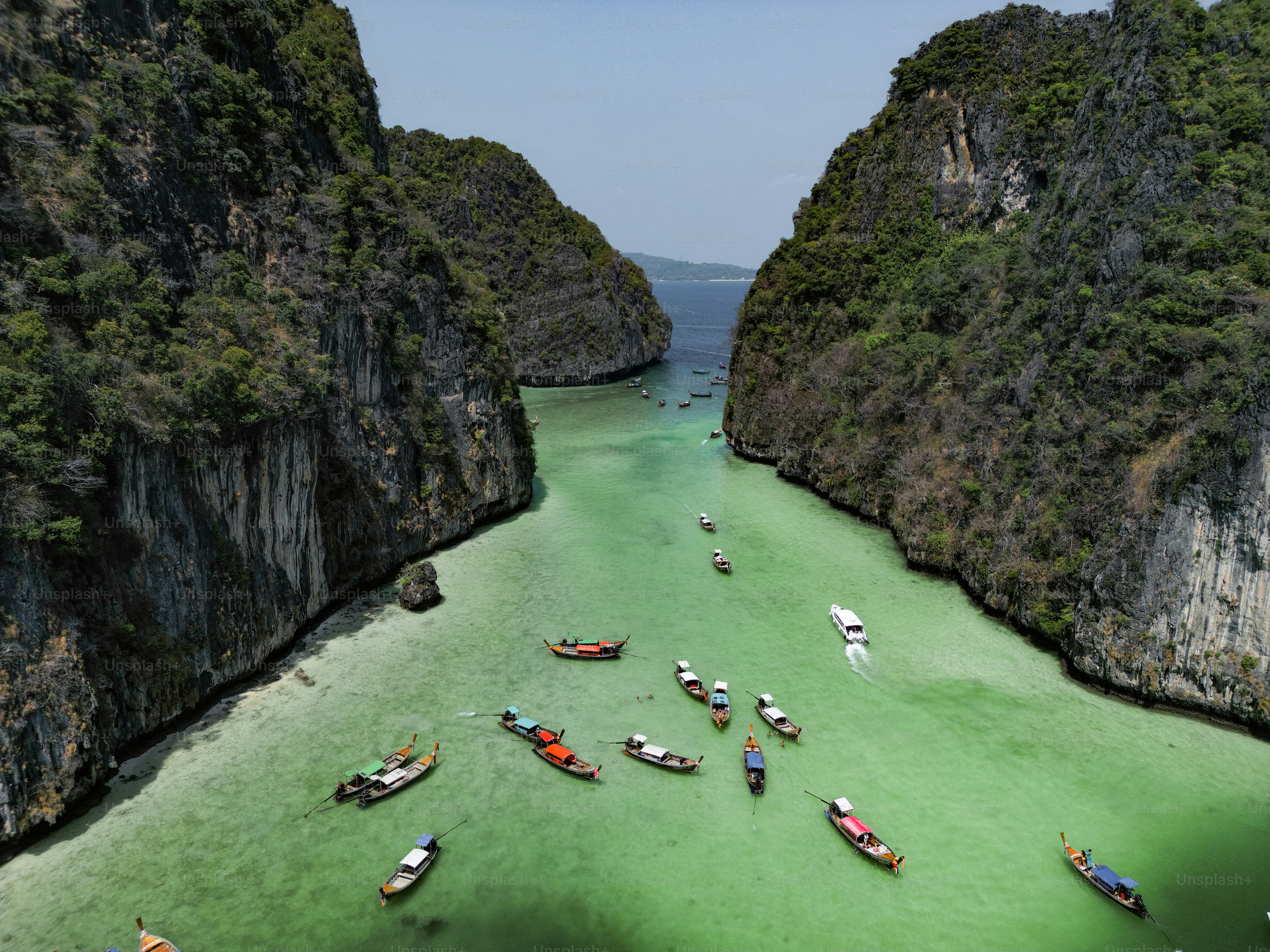 A group of boats floating on top of a body of water