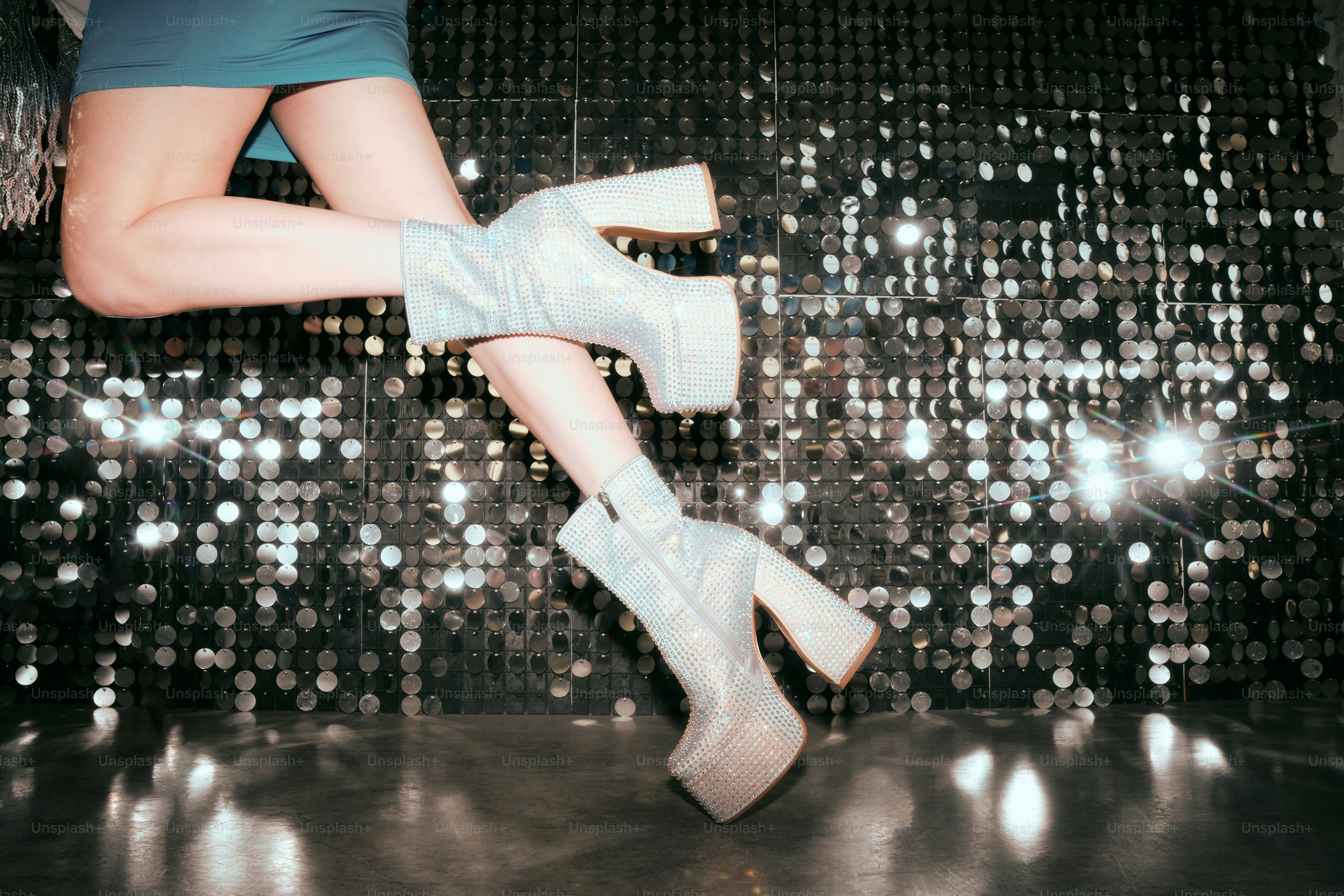 A woman in a blue dress and white boots