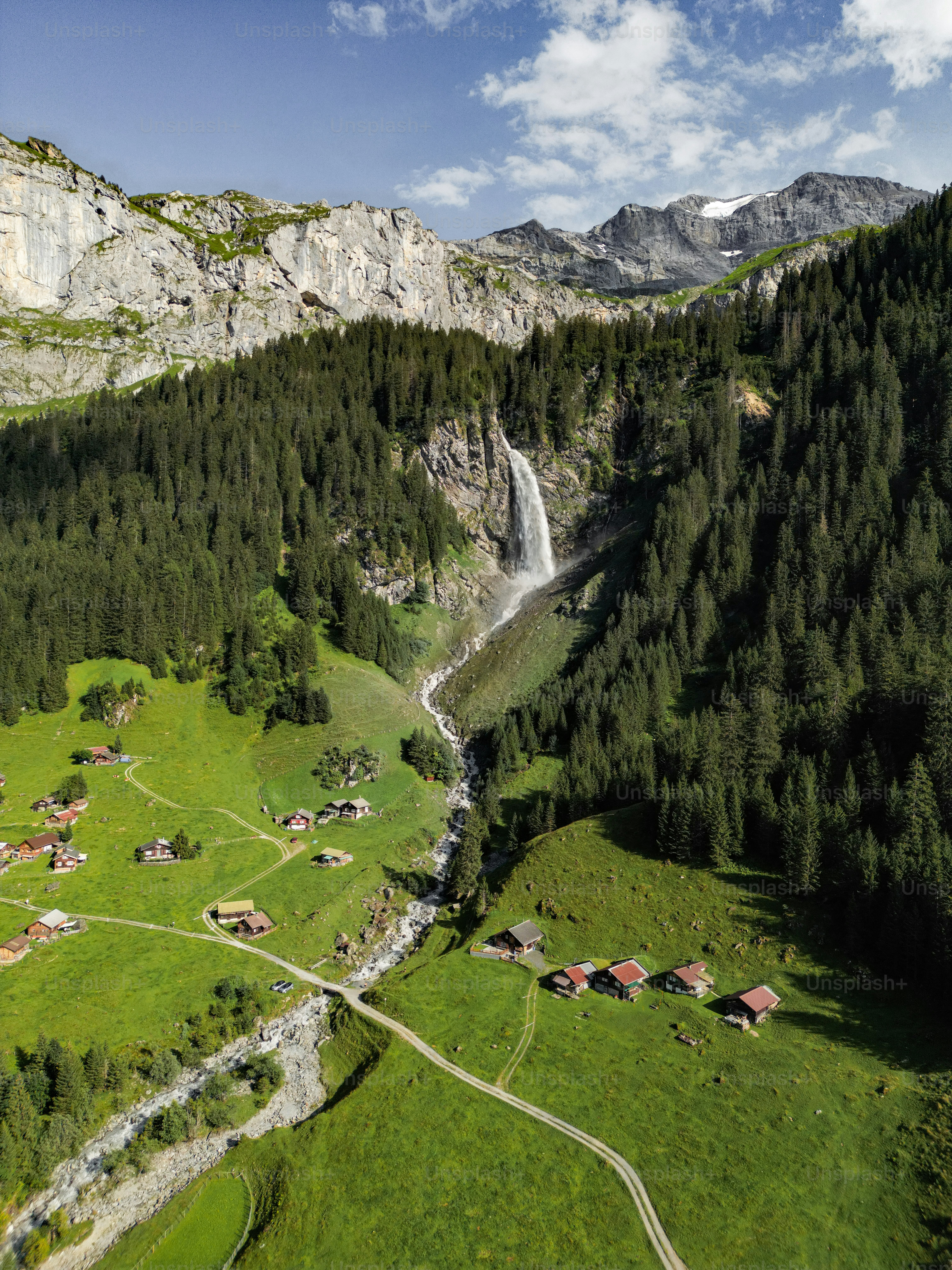 An aerial view of a valley with a waterfall