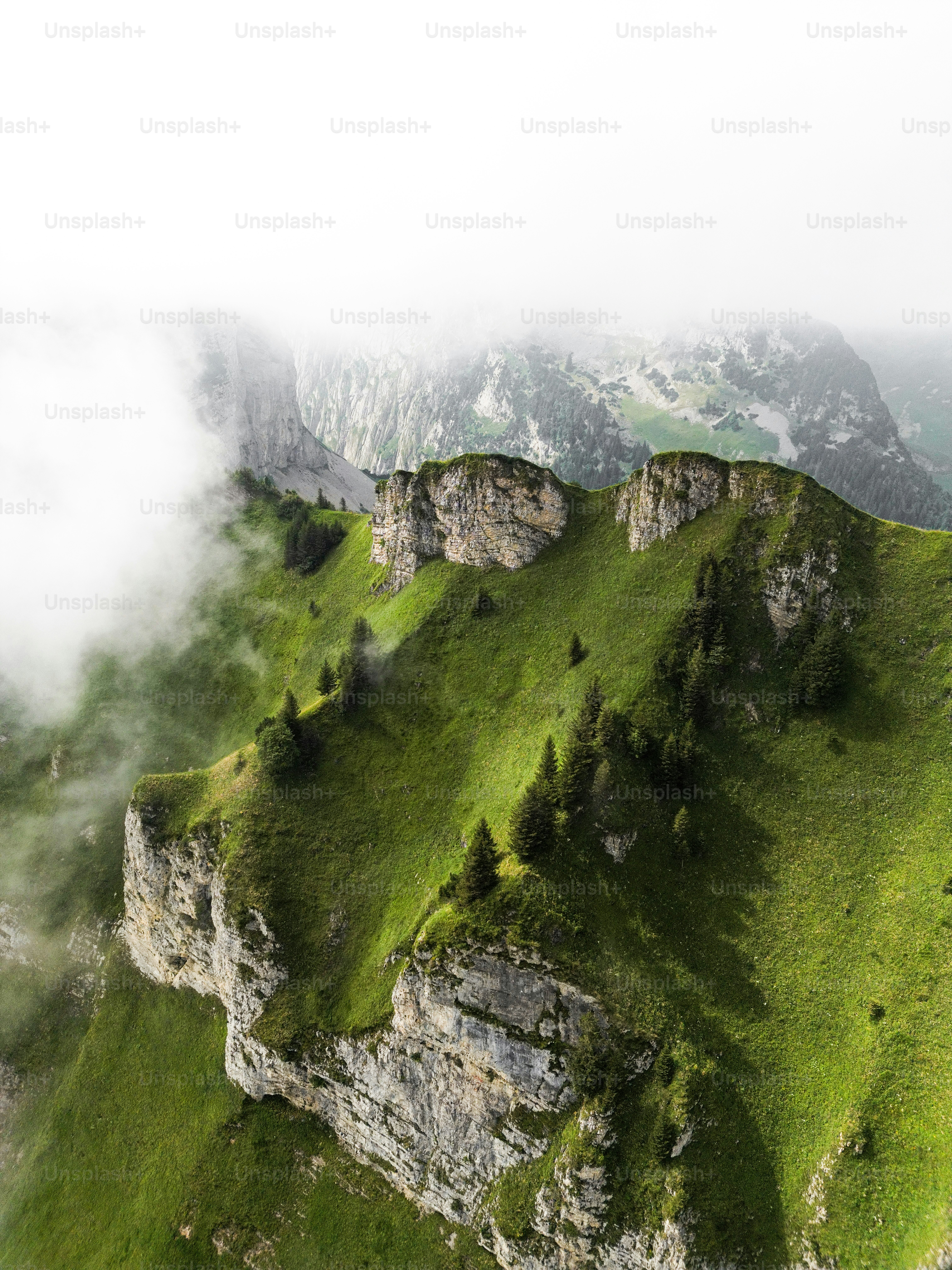 A mountain covered in green grass and clouds