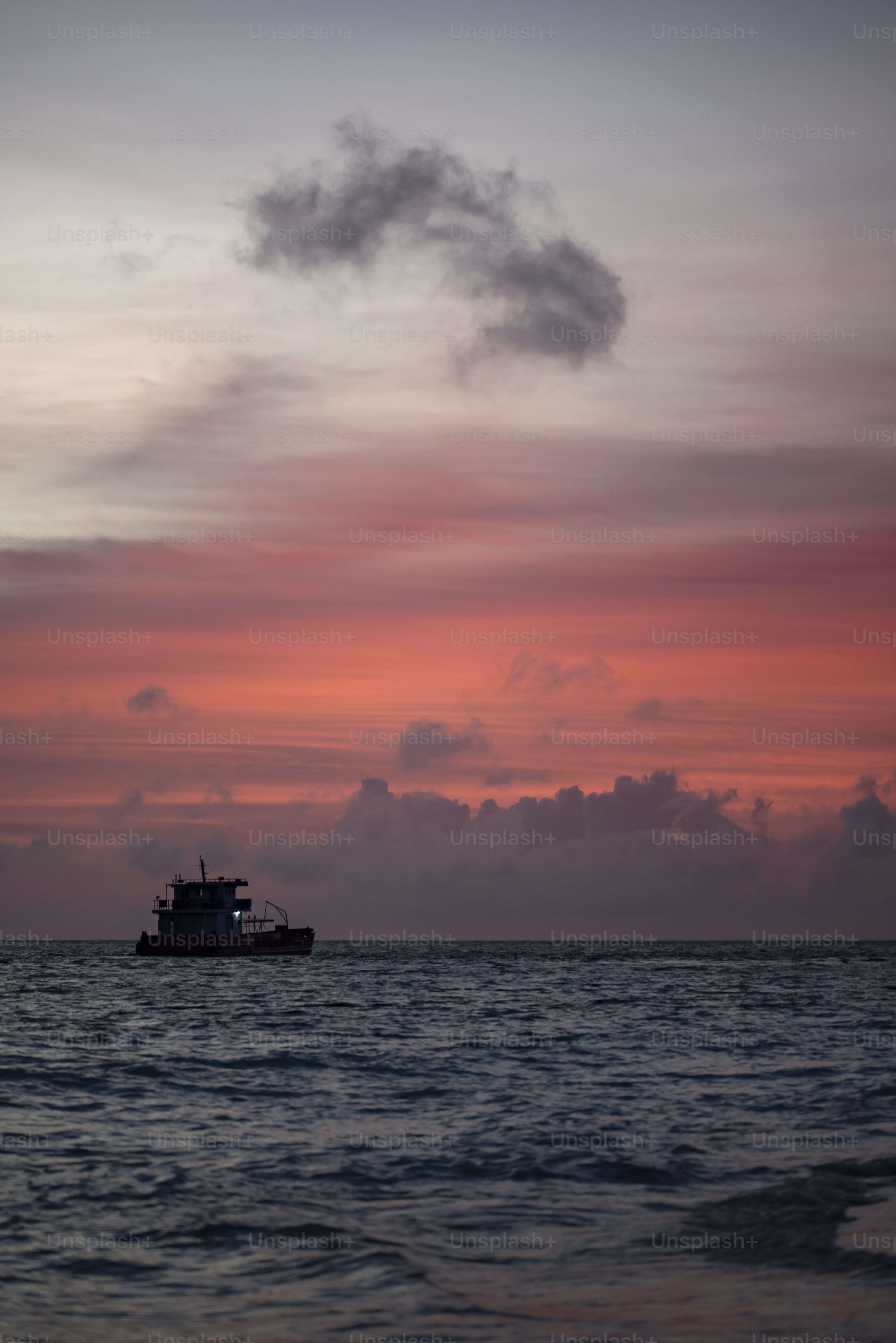 A boat is out on the water at sunset