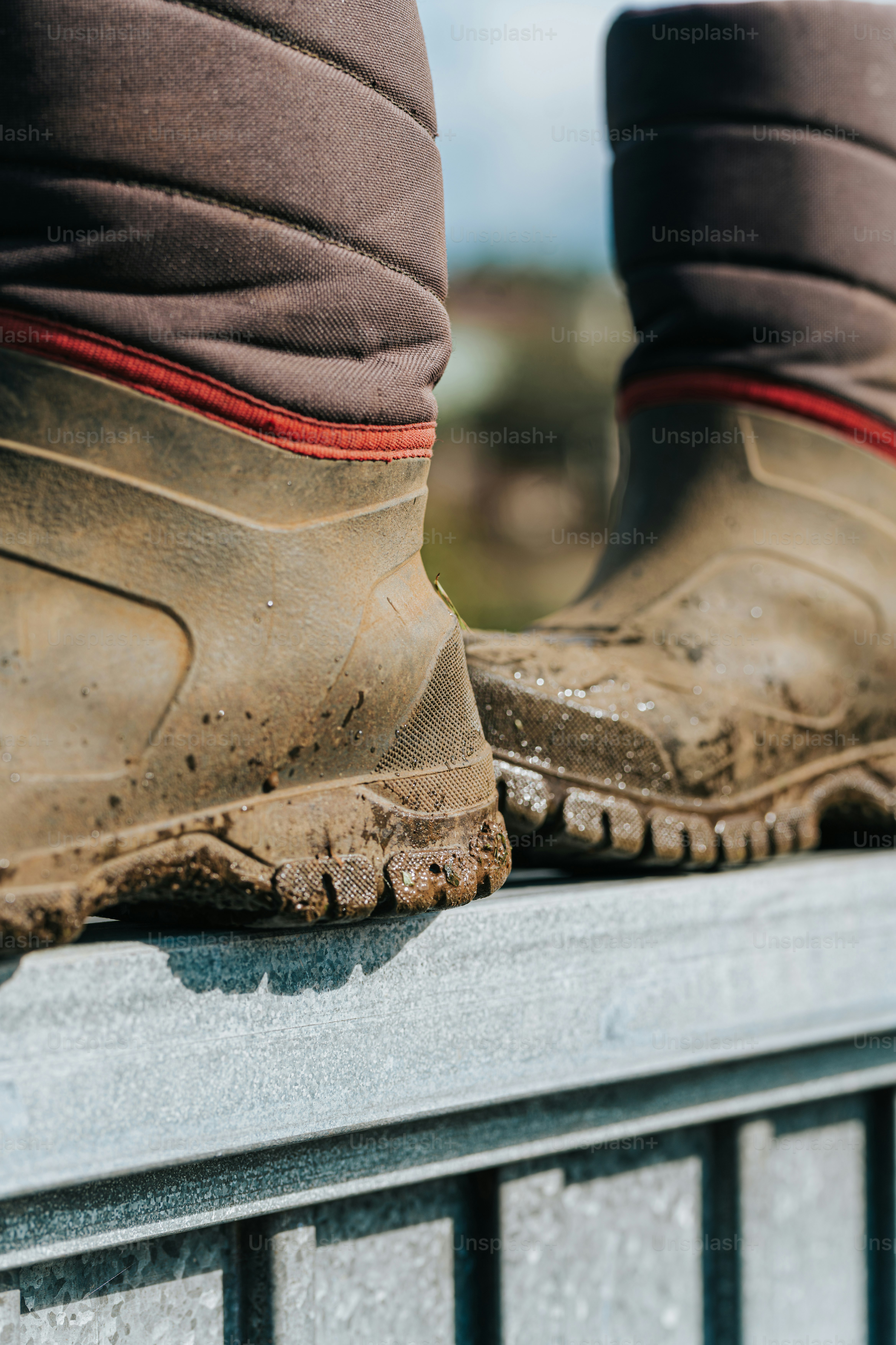 A close up of a person's boots on a ledge