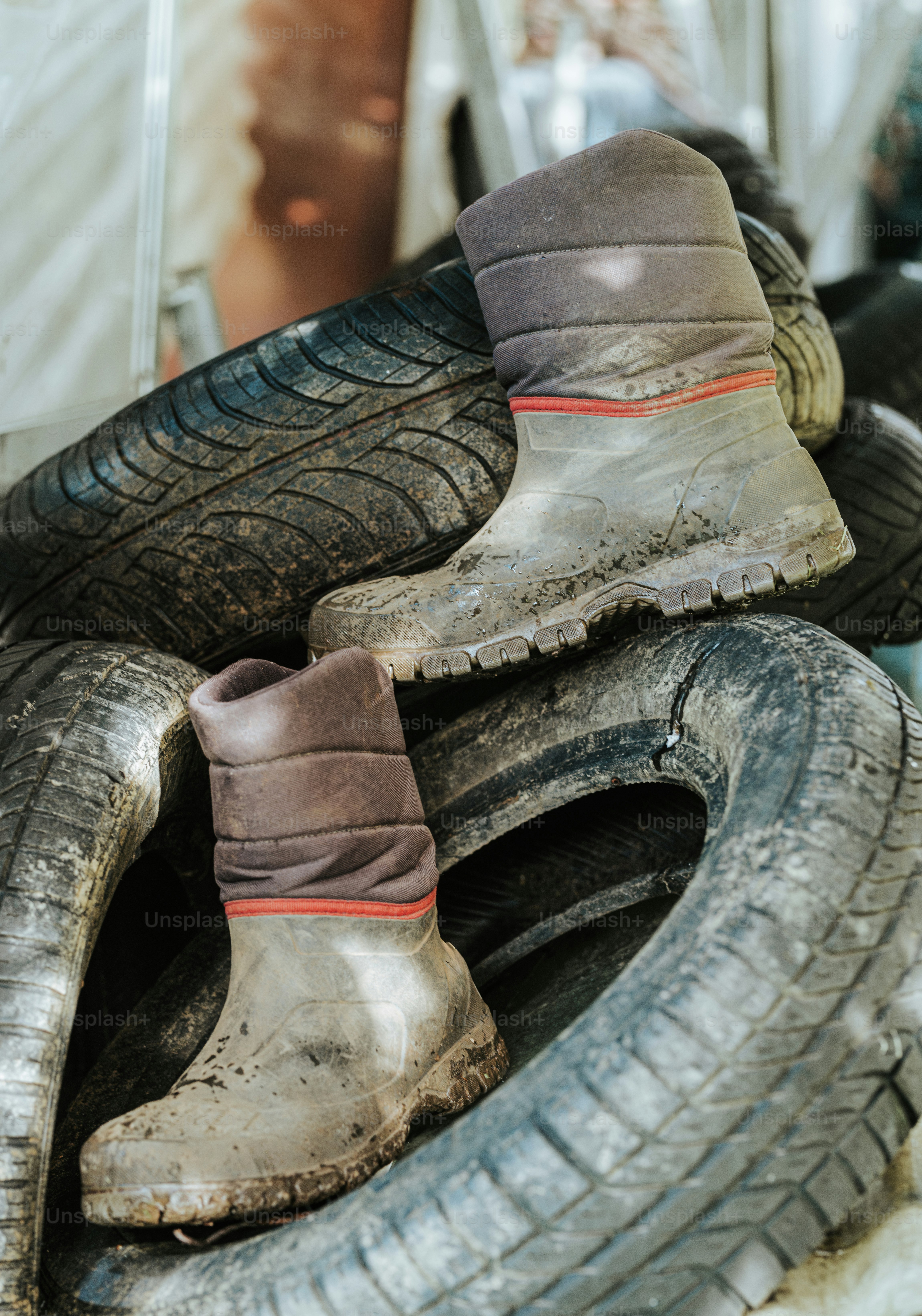 A pile of old worn out tires sitting on top of each other