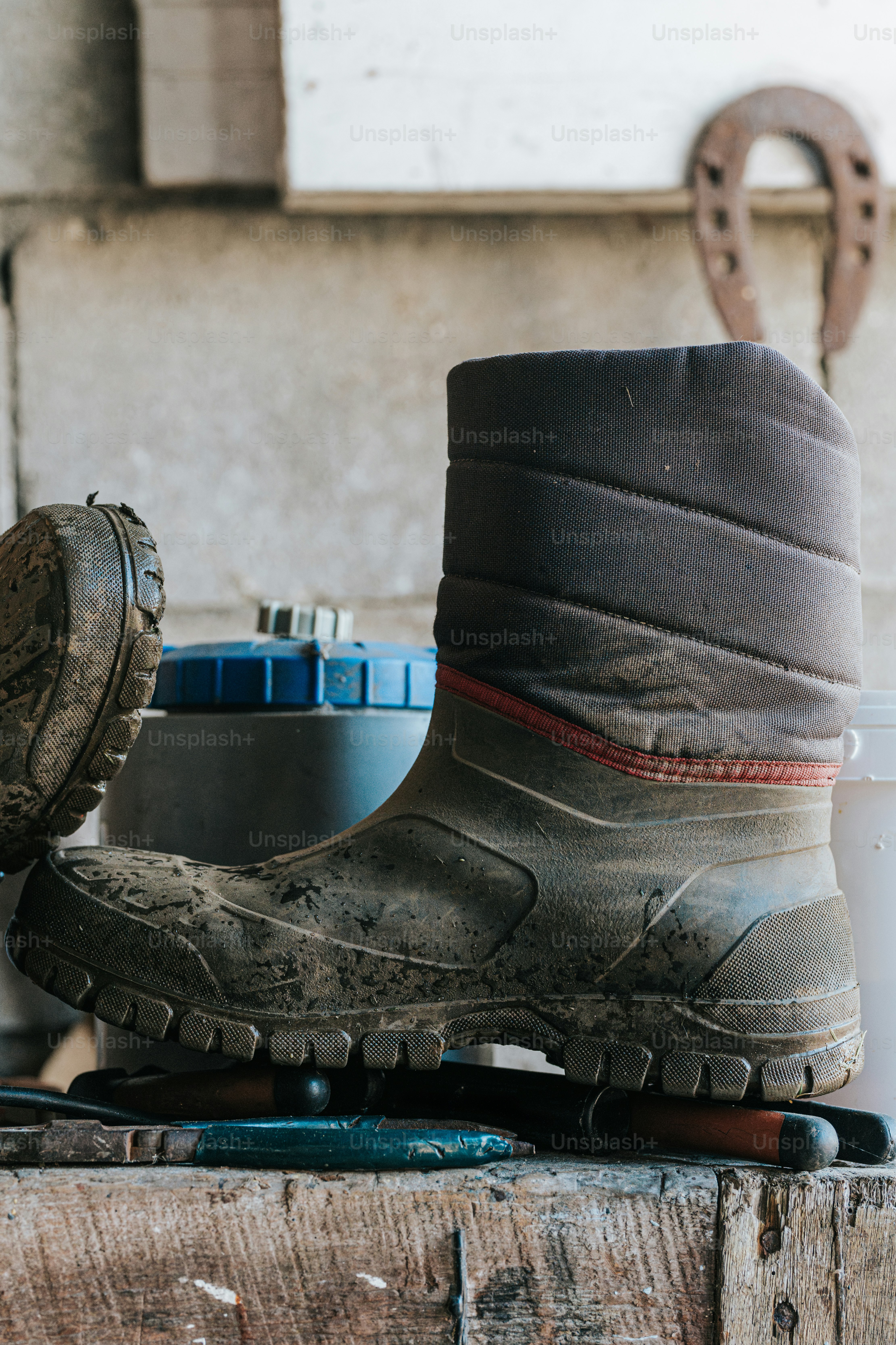 A pair of boots sitting on top of a wooden table