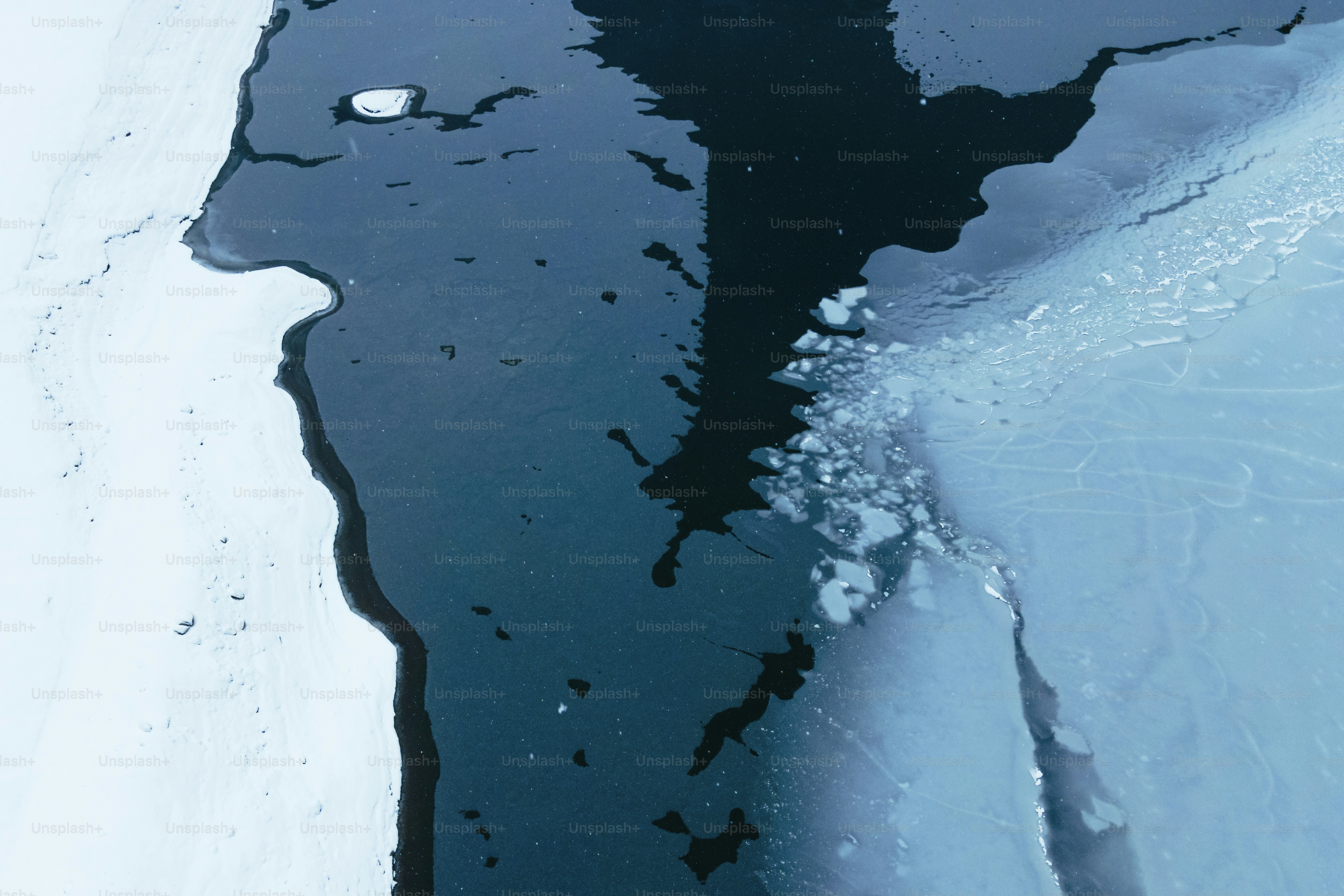 A large body of water surrounded by snow