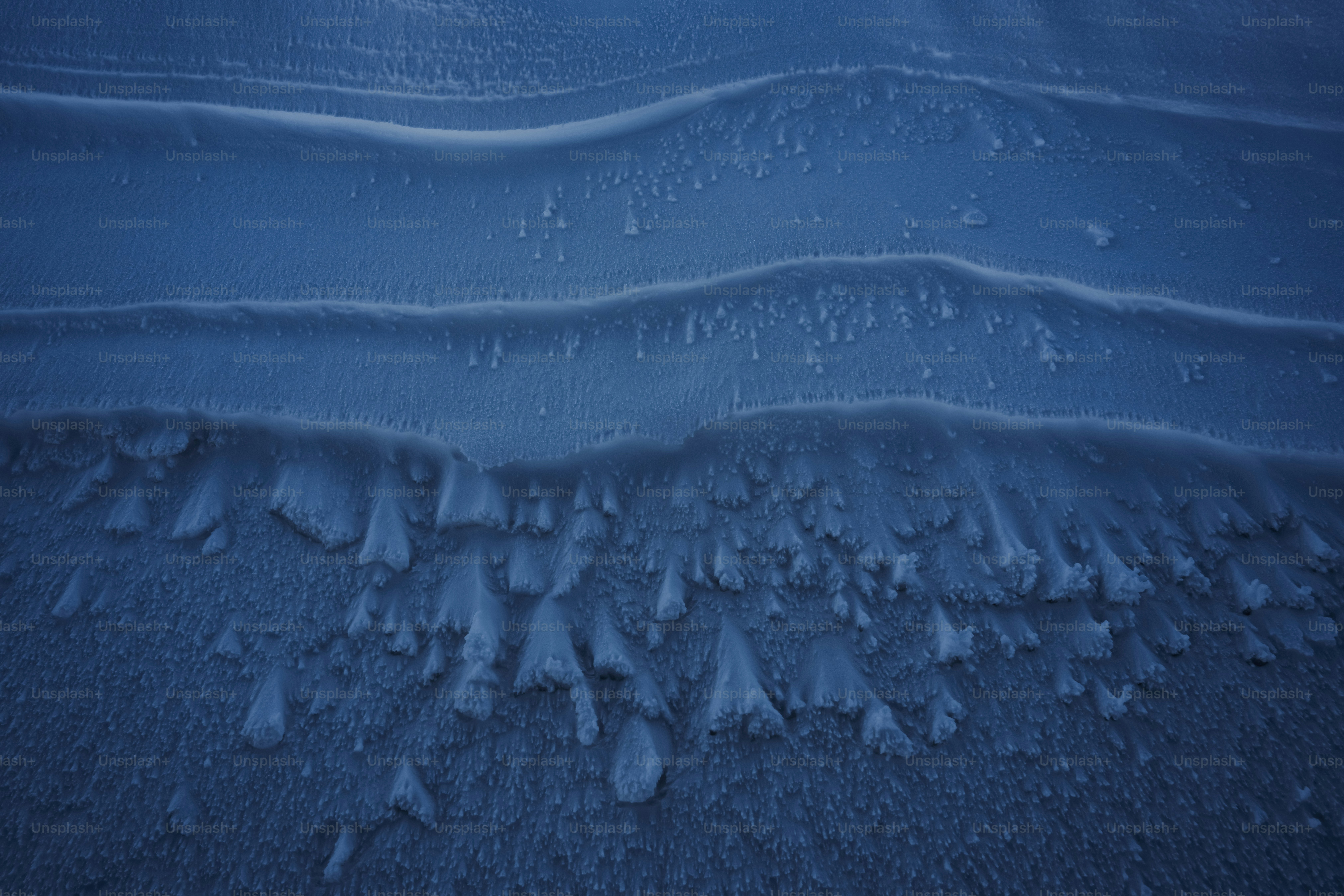 A snow covered field with a bright sun in the background