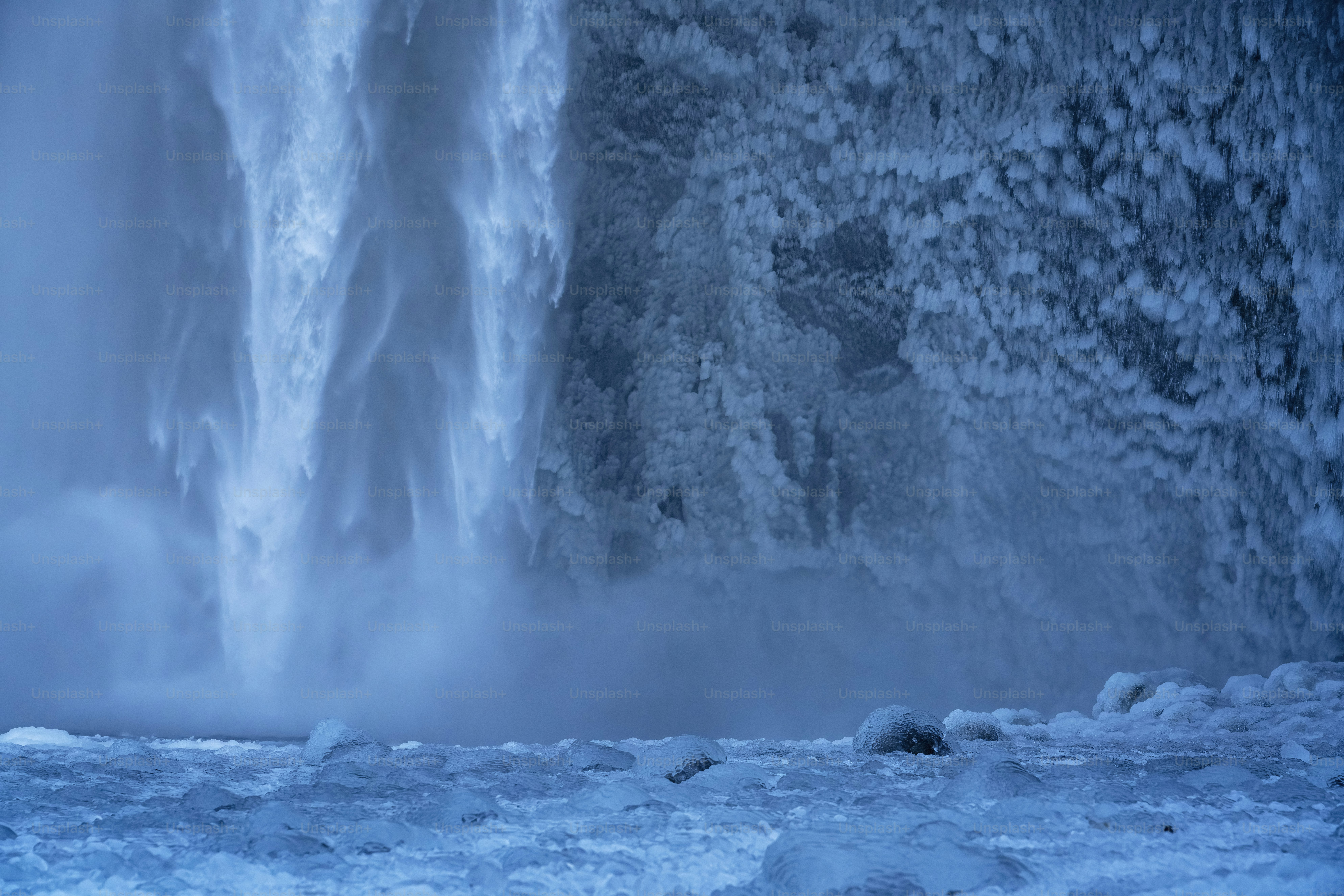 A man standing in front of a waterfall