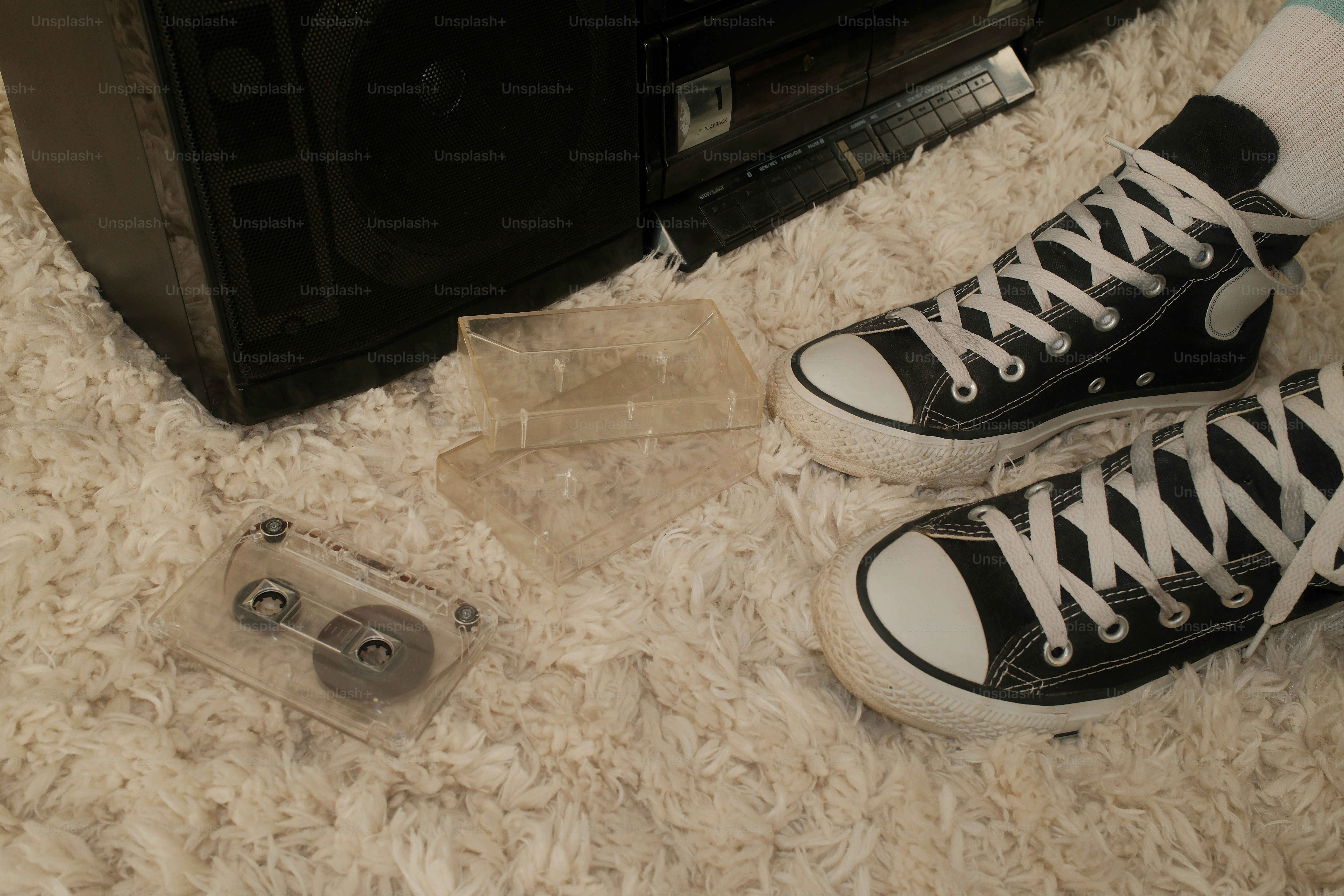 A pair of black and white sneakers on a carpet