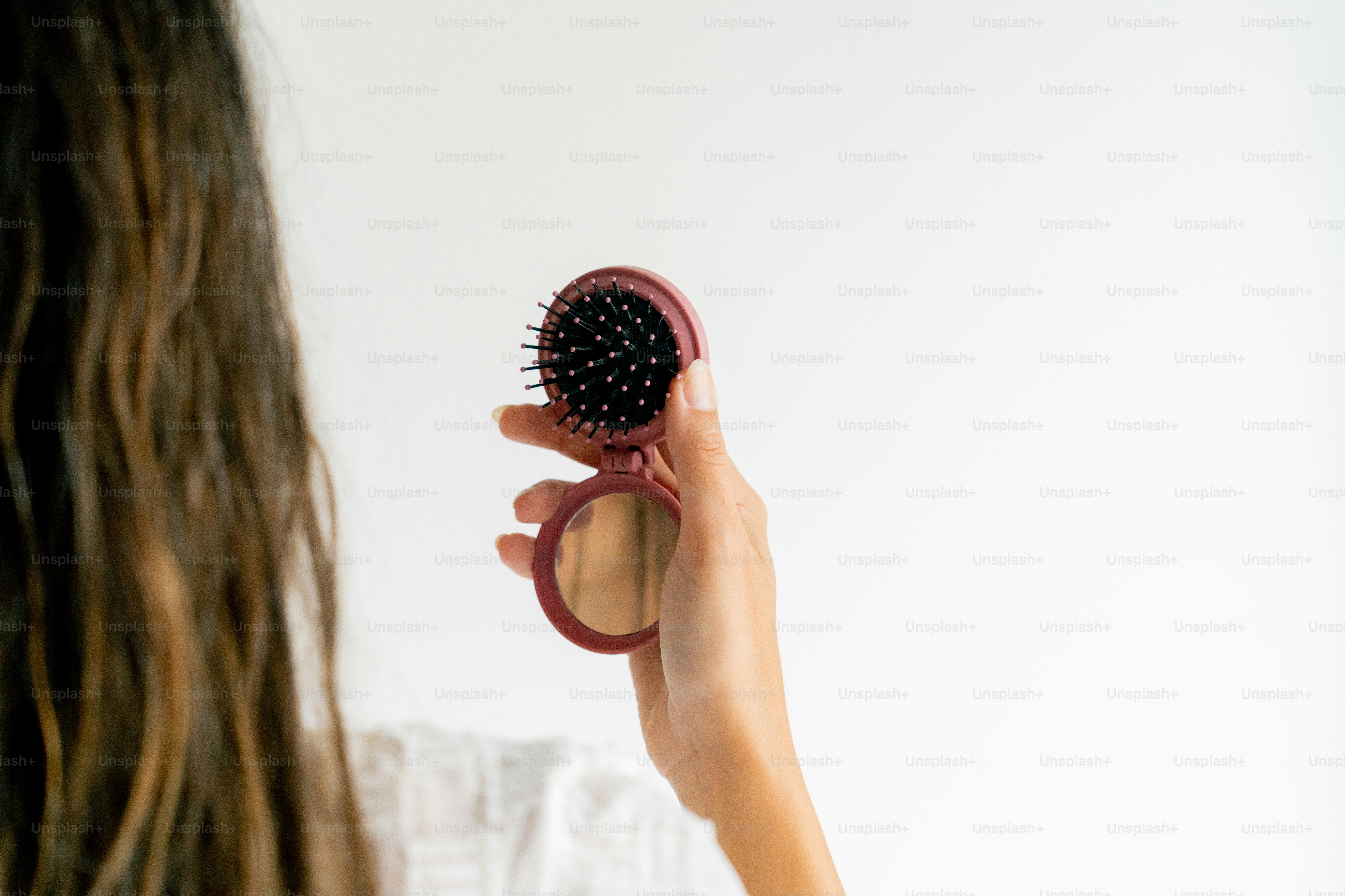 A woman is holding a round object in her hand