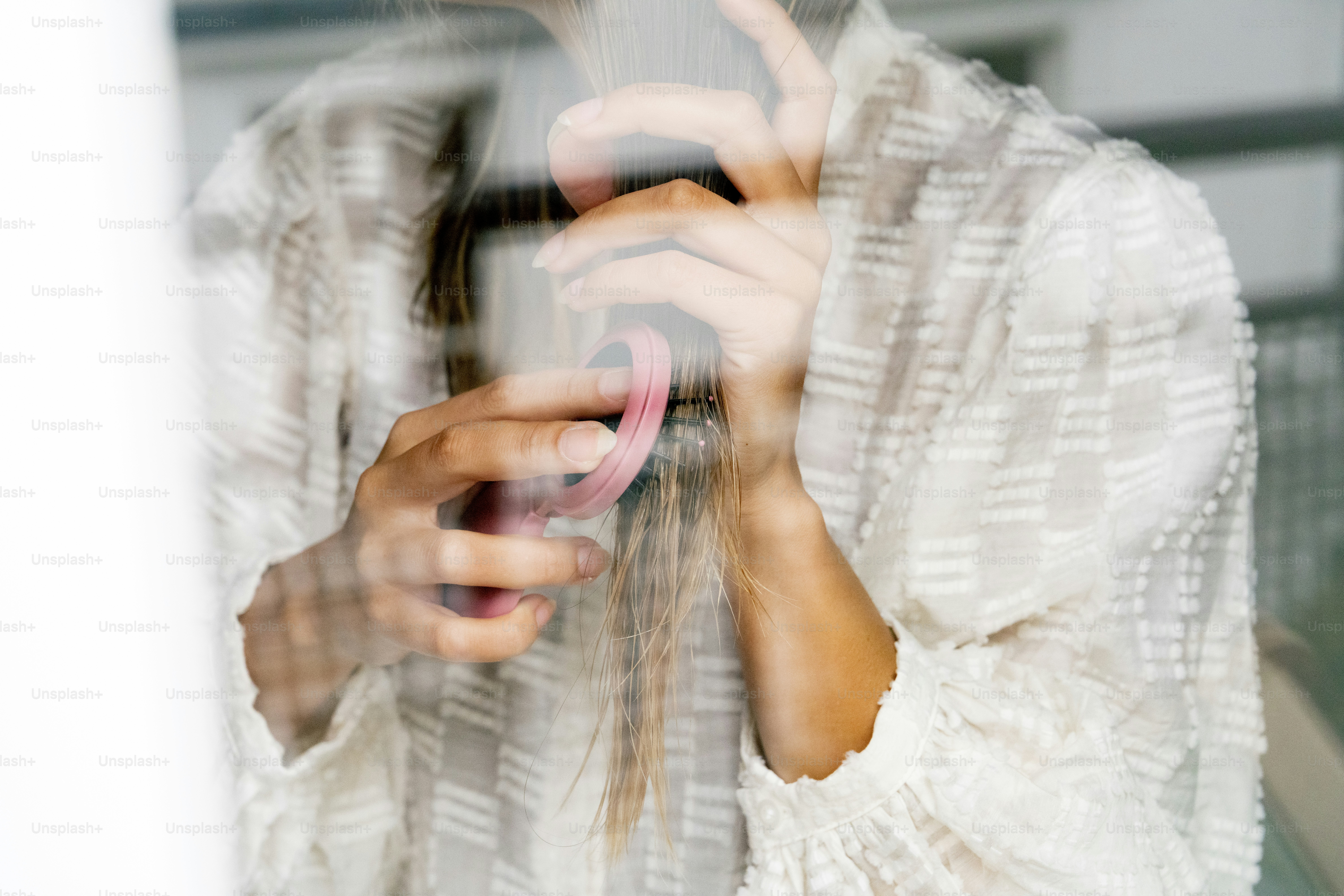 A woman holding a cell phone up to her face