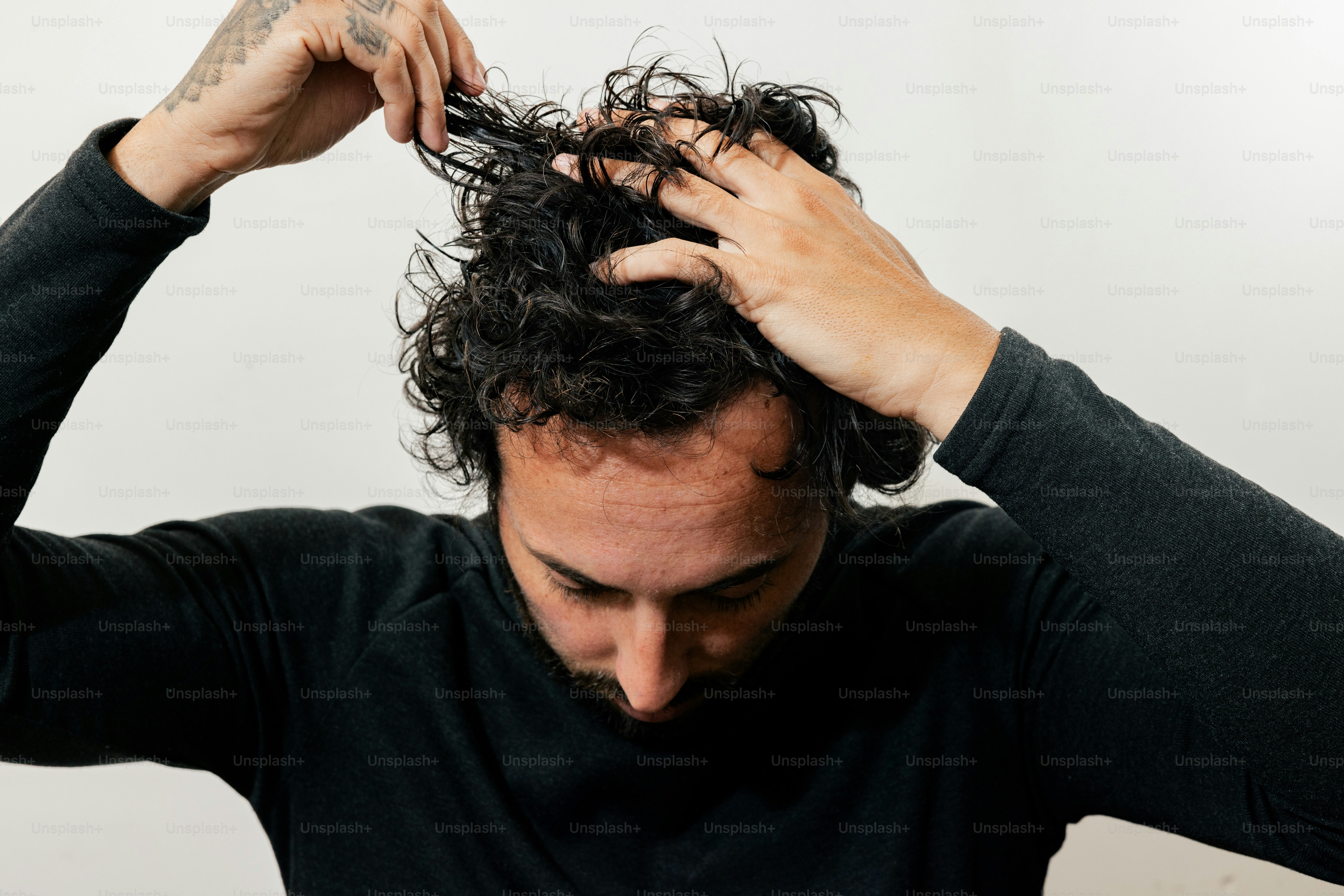 A man holding his hair up to his head