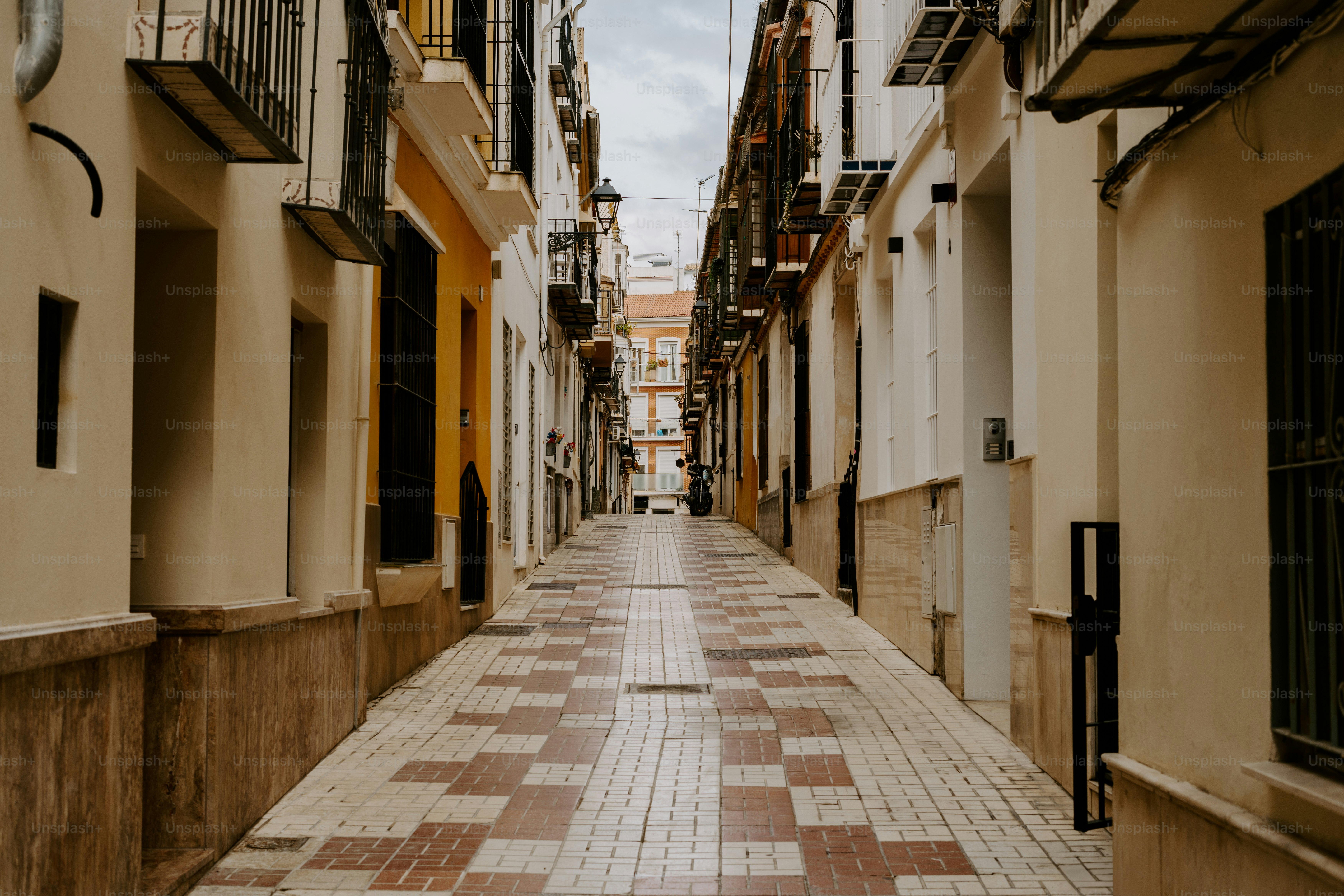 A narrow city street lined with tall buildings