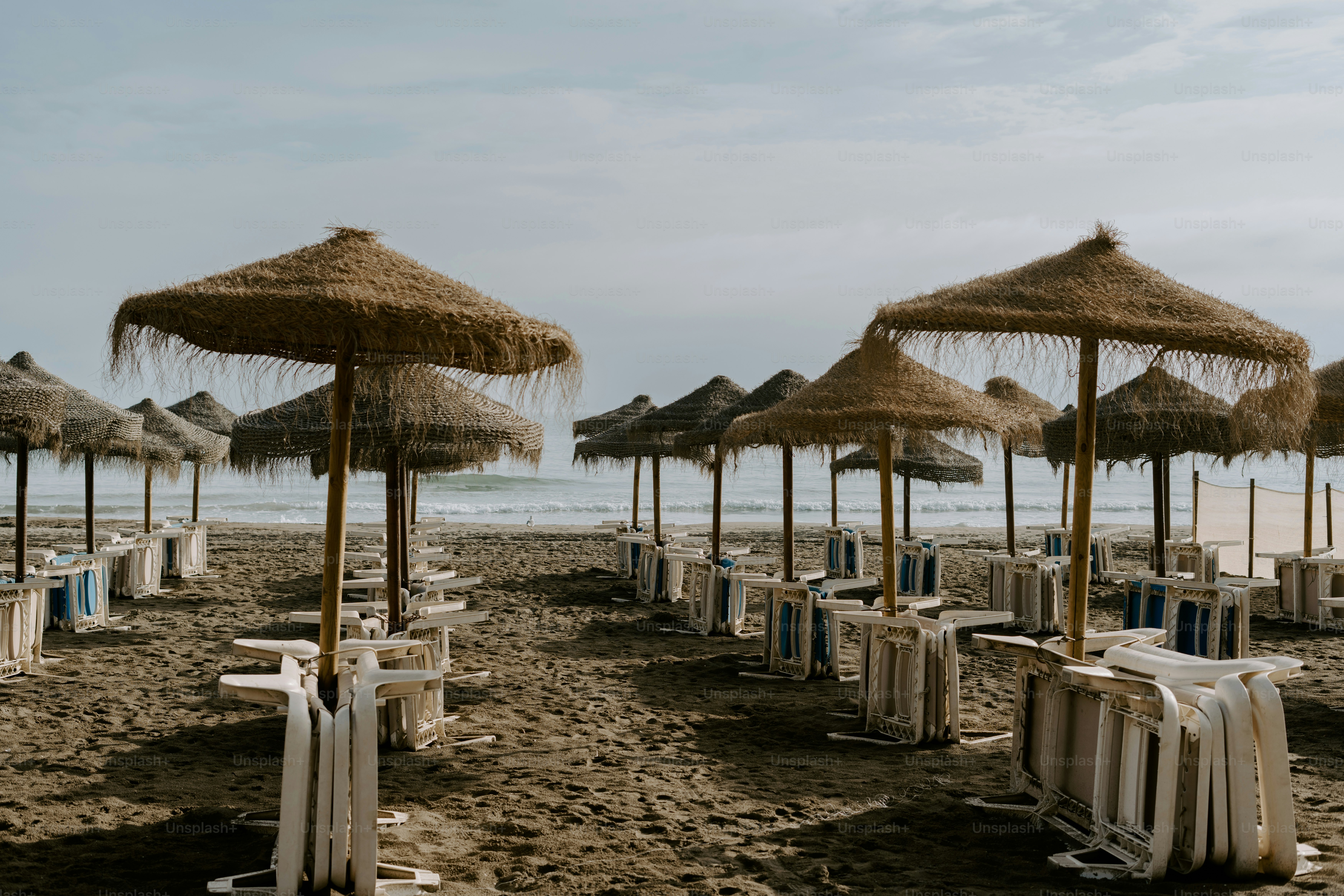 A bunch of umbrellas that are on a beach