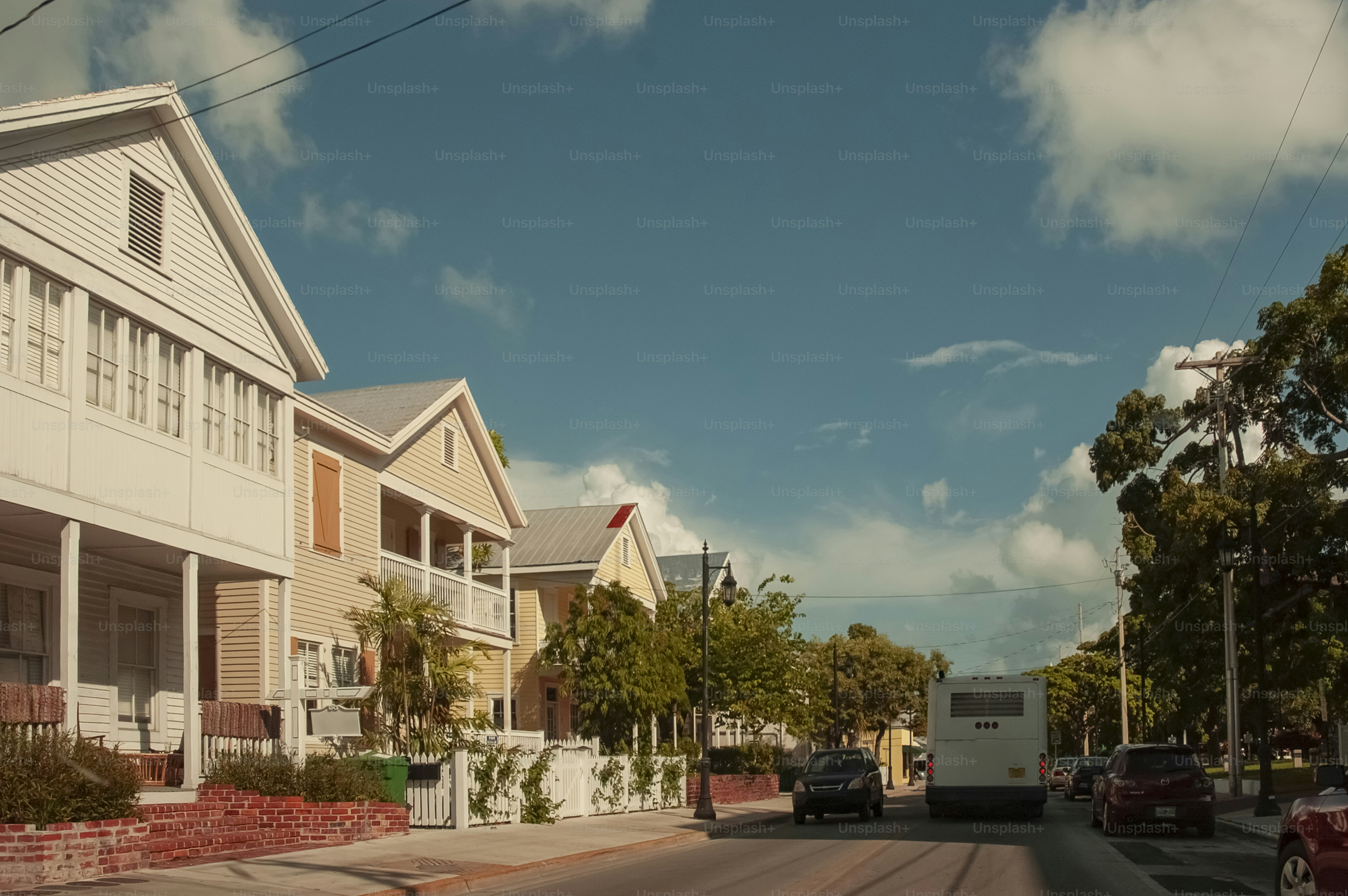 A street lined with houses and parked cars