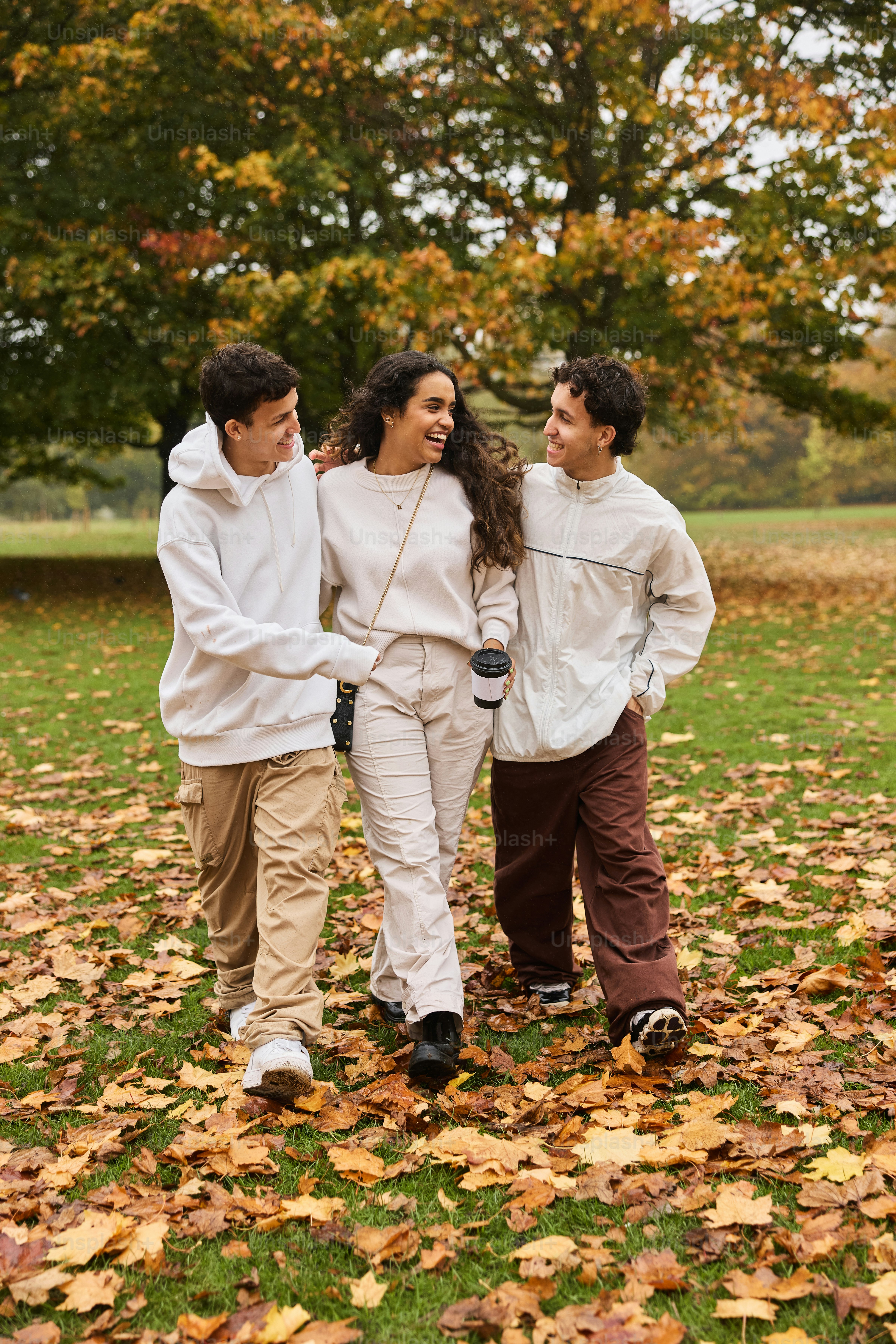 A group of people walking through a leaf covered field