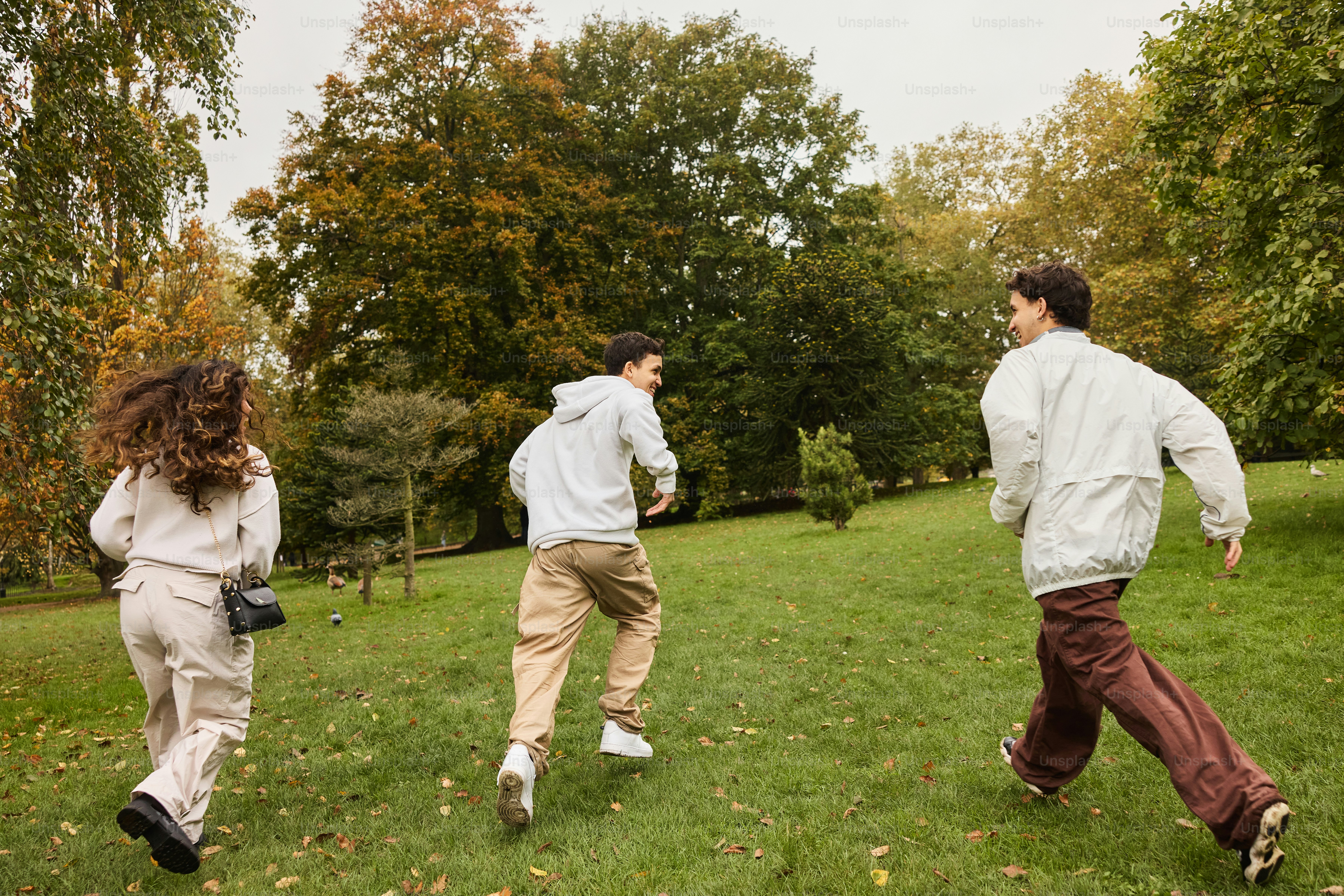 A group of people running across a lush green field