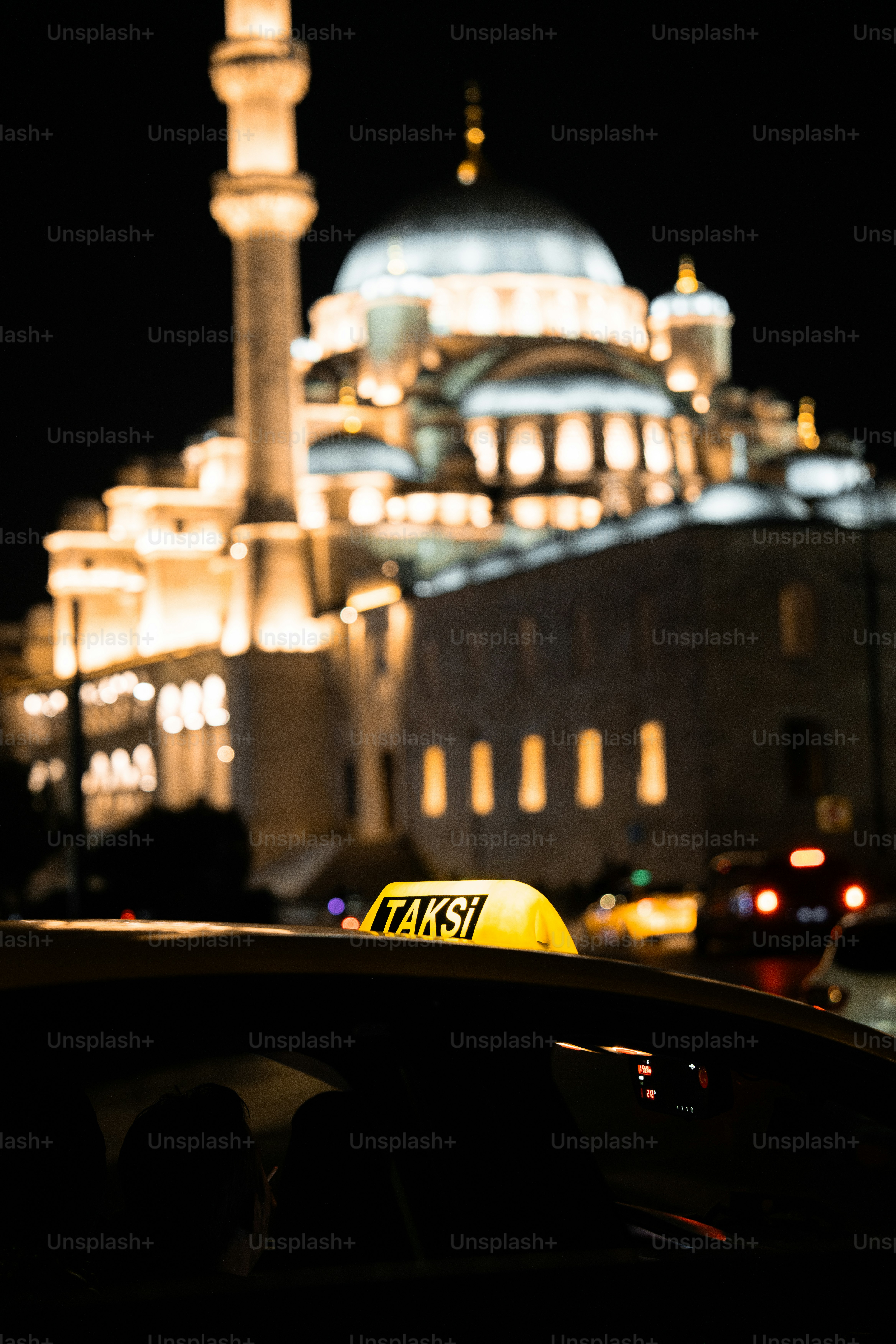 A taxi cab parked in front of a large building