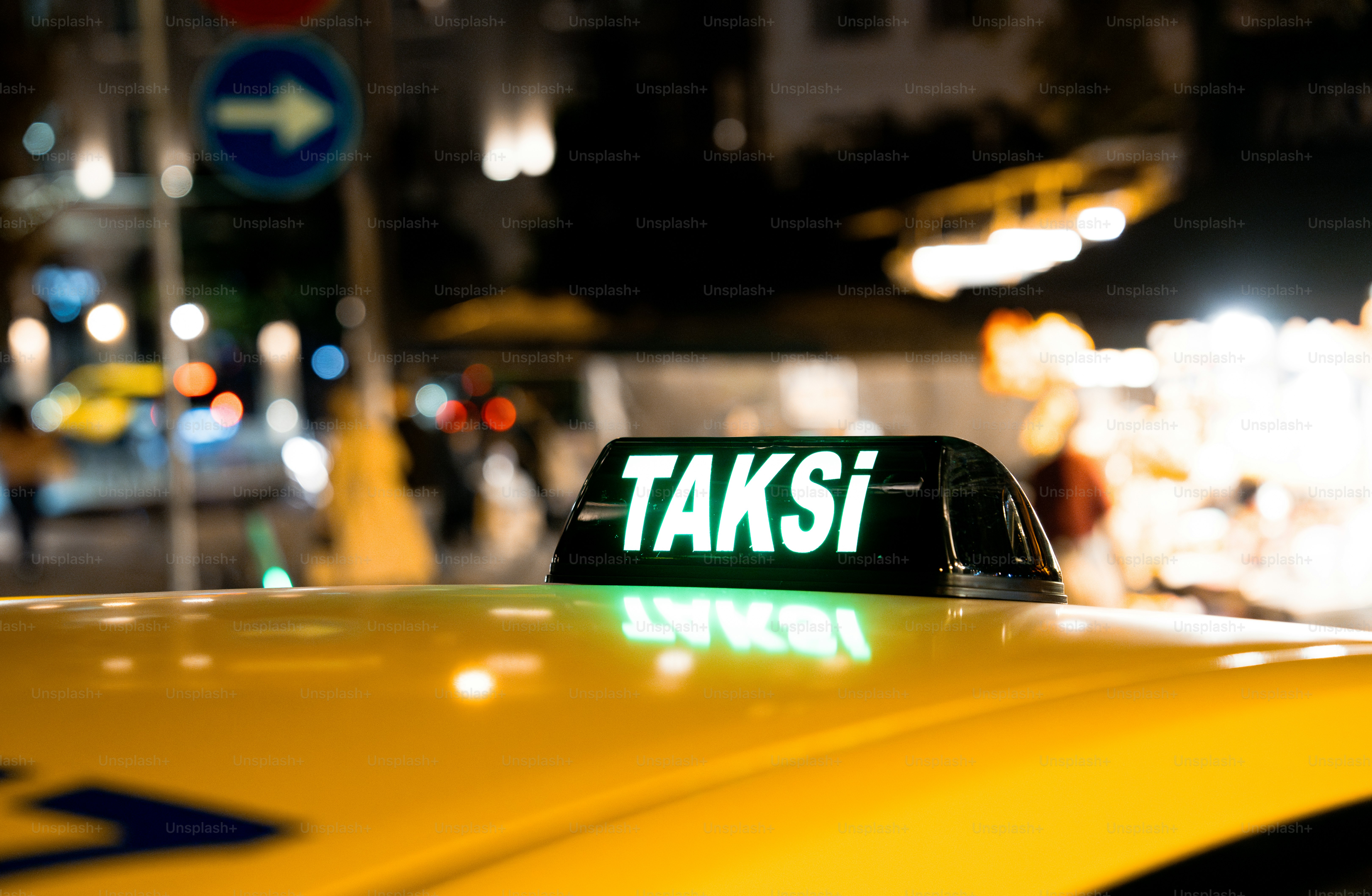 A taxi cab that is sitting in the street