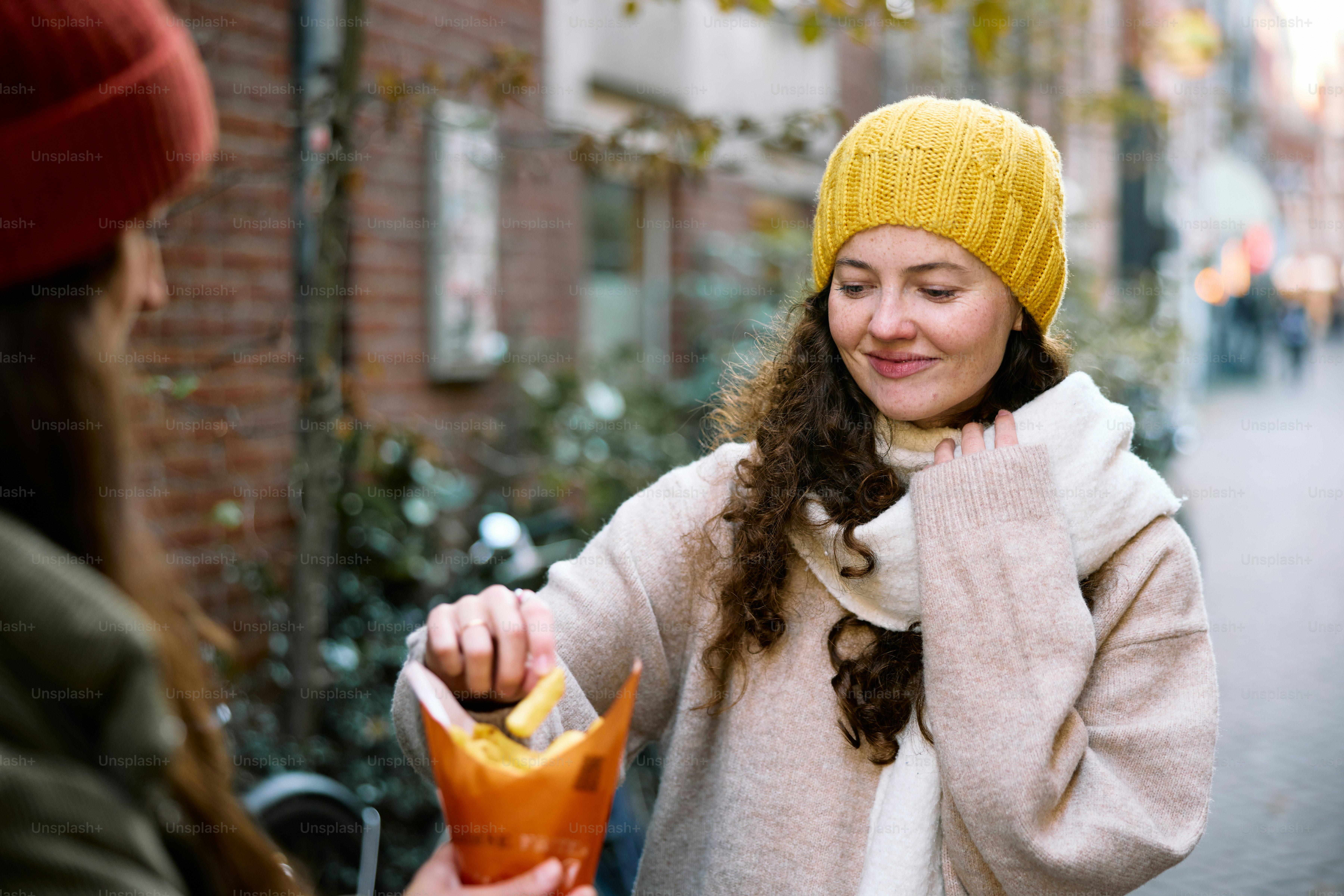 A woman holding a hot dog in her hand