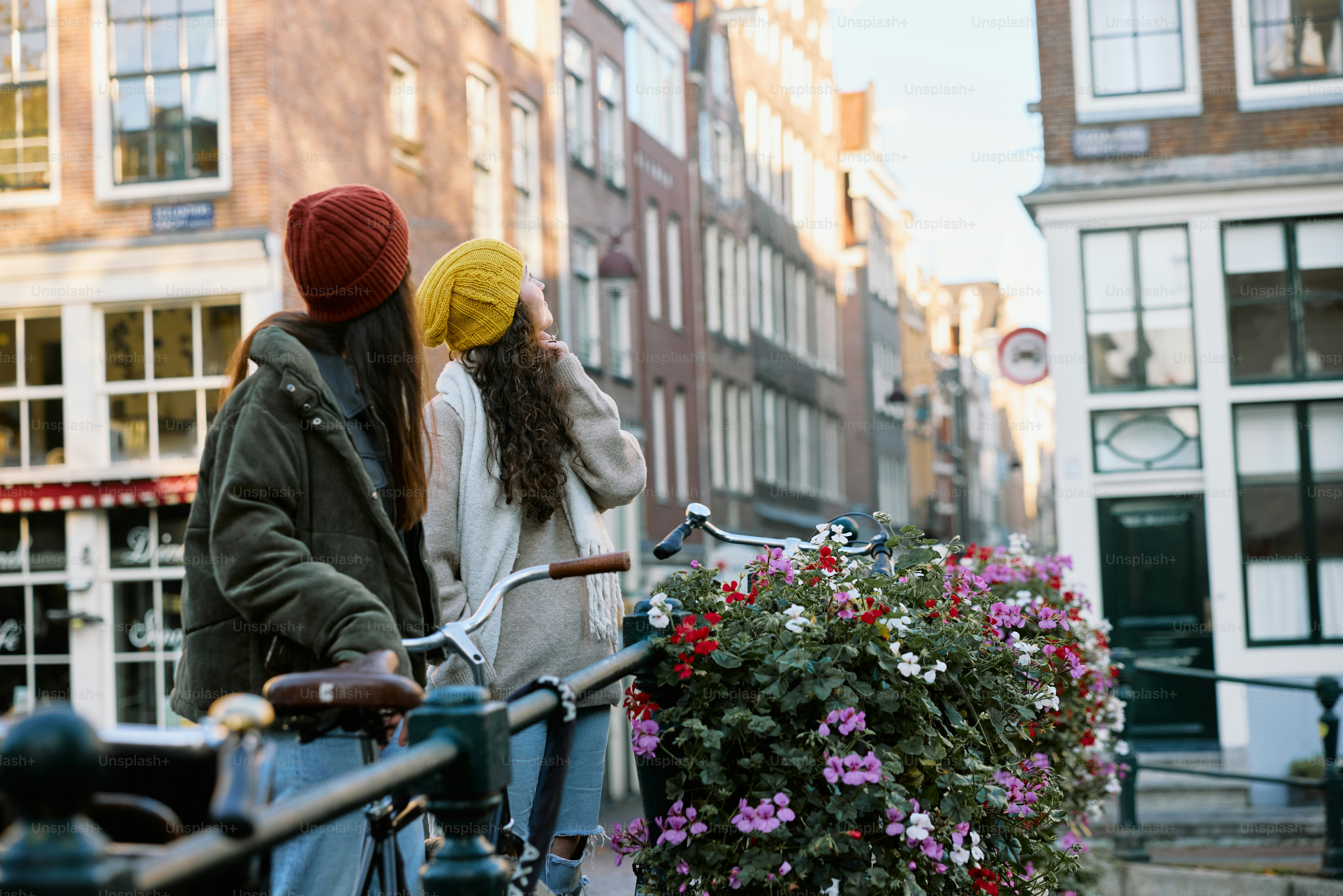 A couple of people standing next to a bike