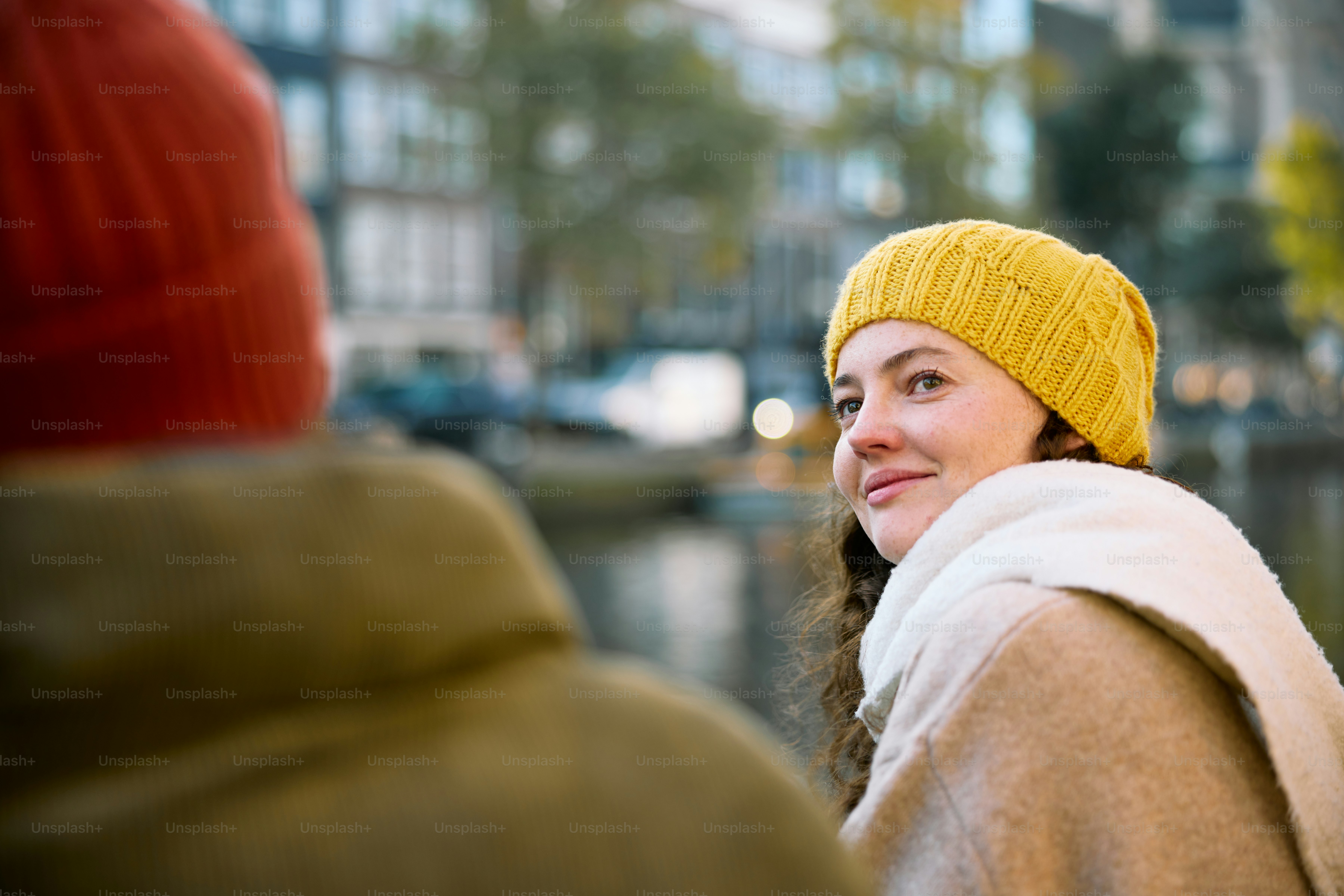 A woman in a yellow hat and a man in a brown coat