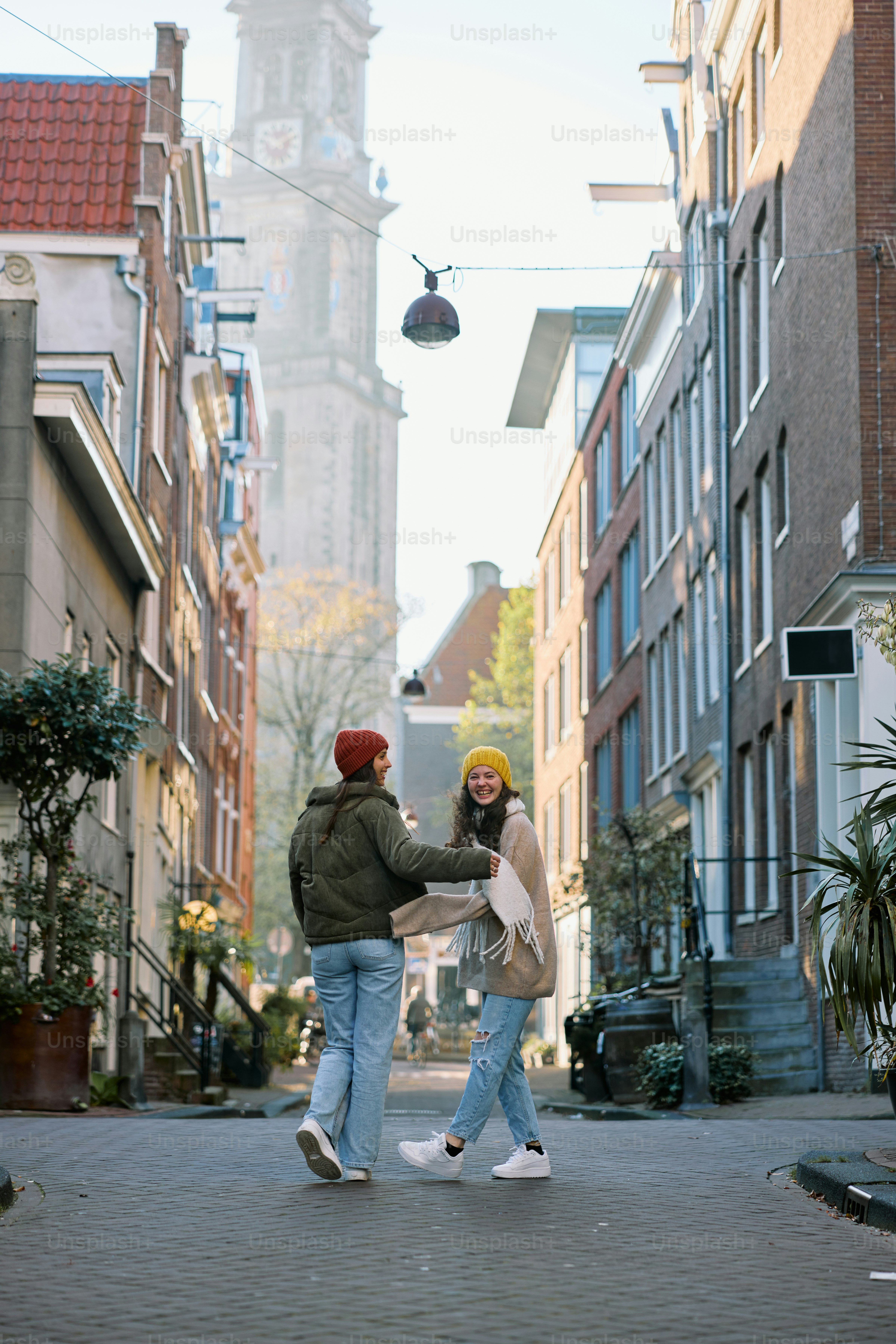 A couple of people that are standing in the street