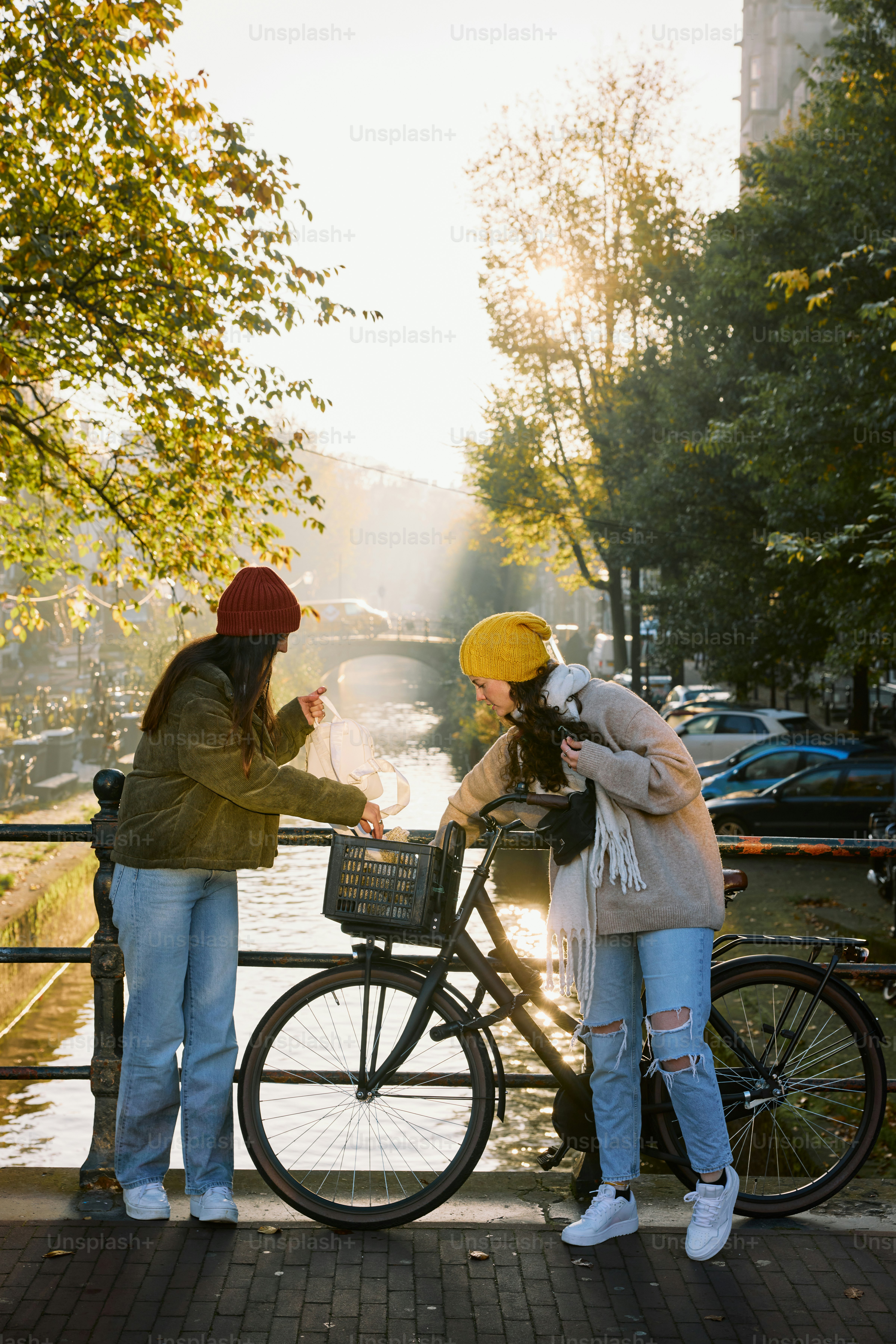 A couple of people standing next to a bike
