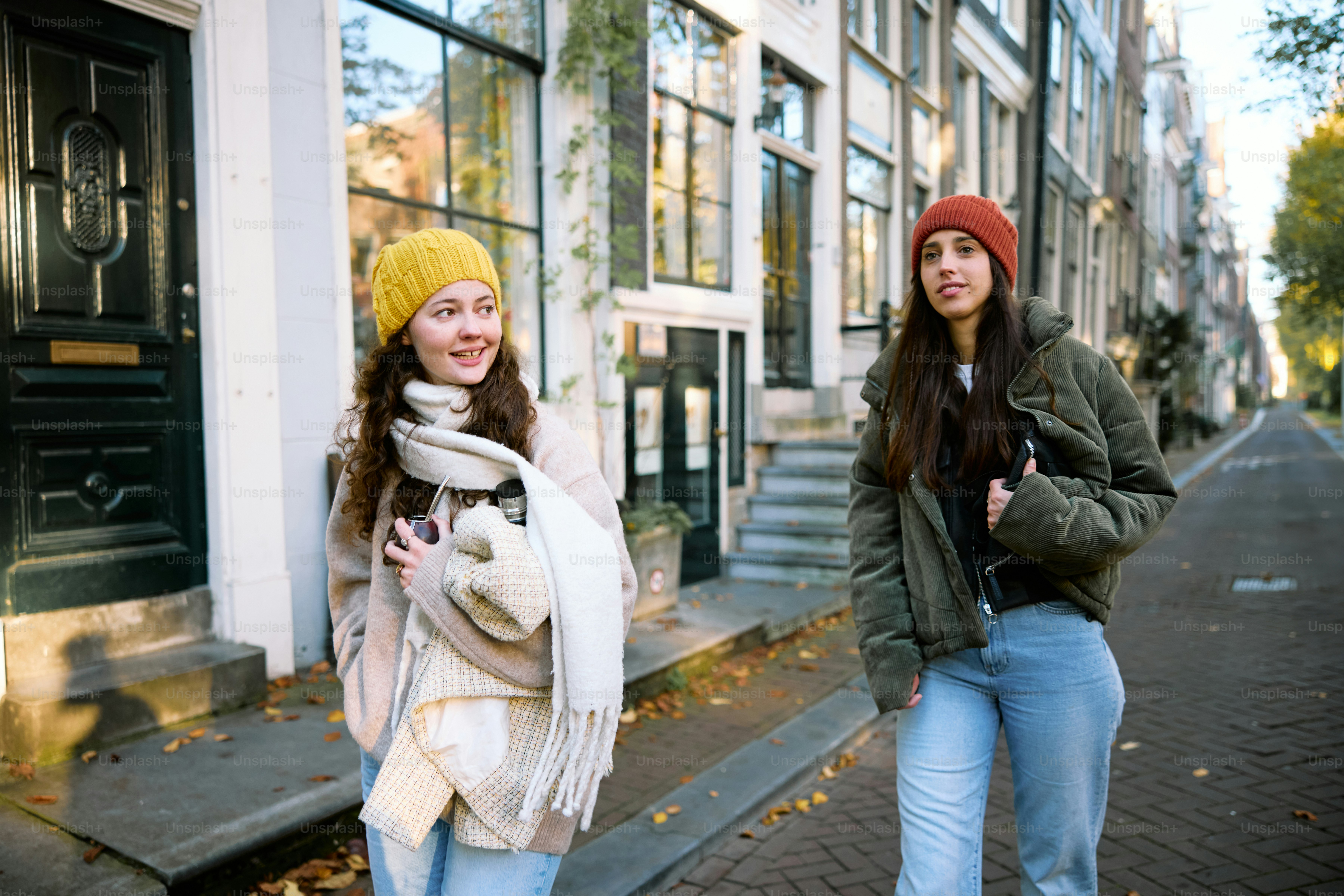Two young women walking down a city street