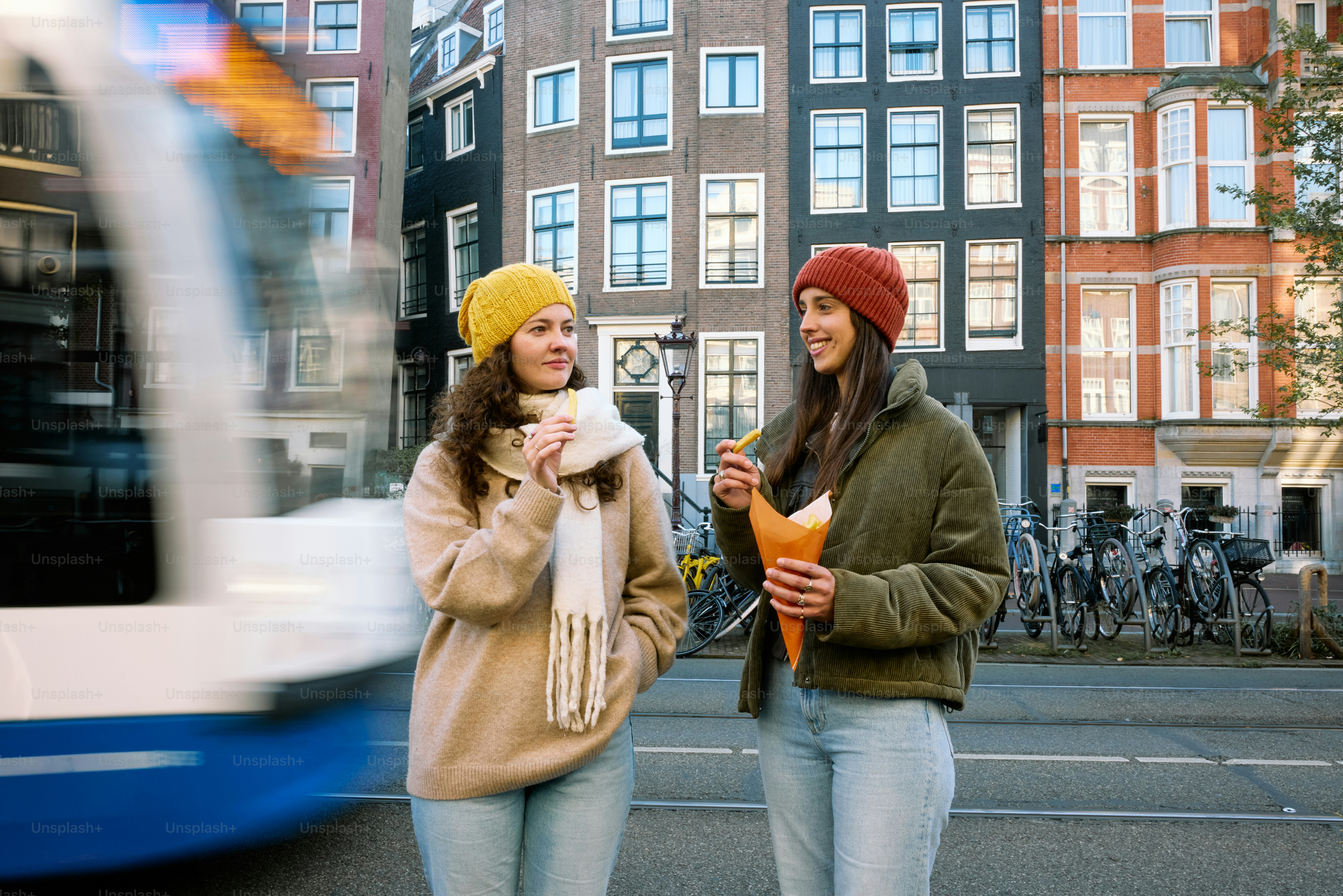 Two women standing on the side of the road