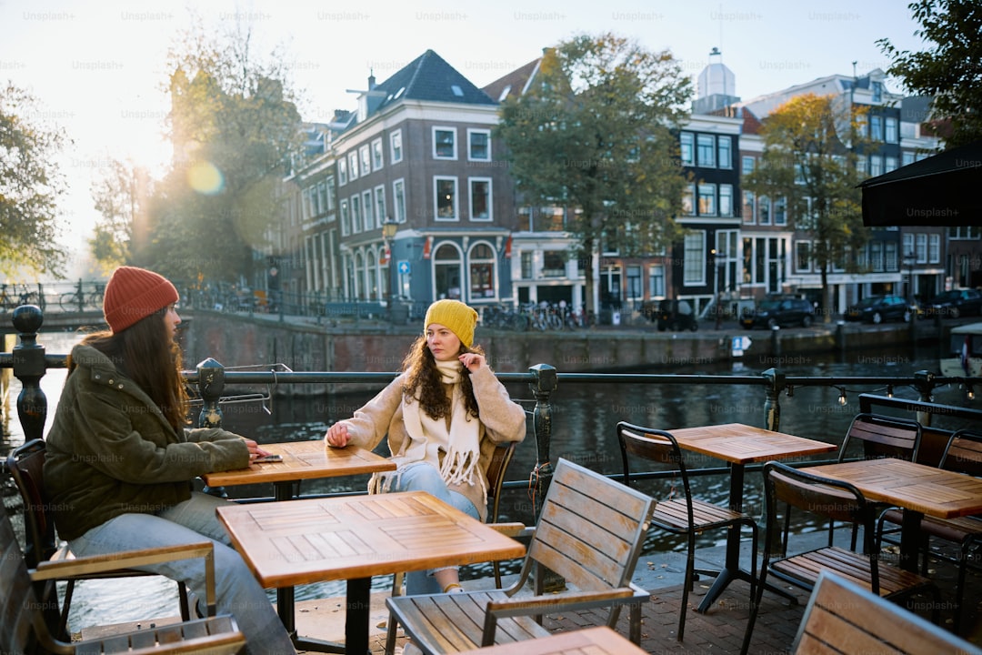 A couple of people sitting at a table next to each other