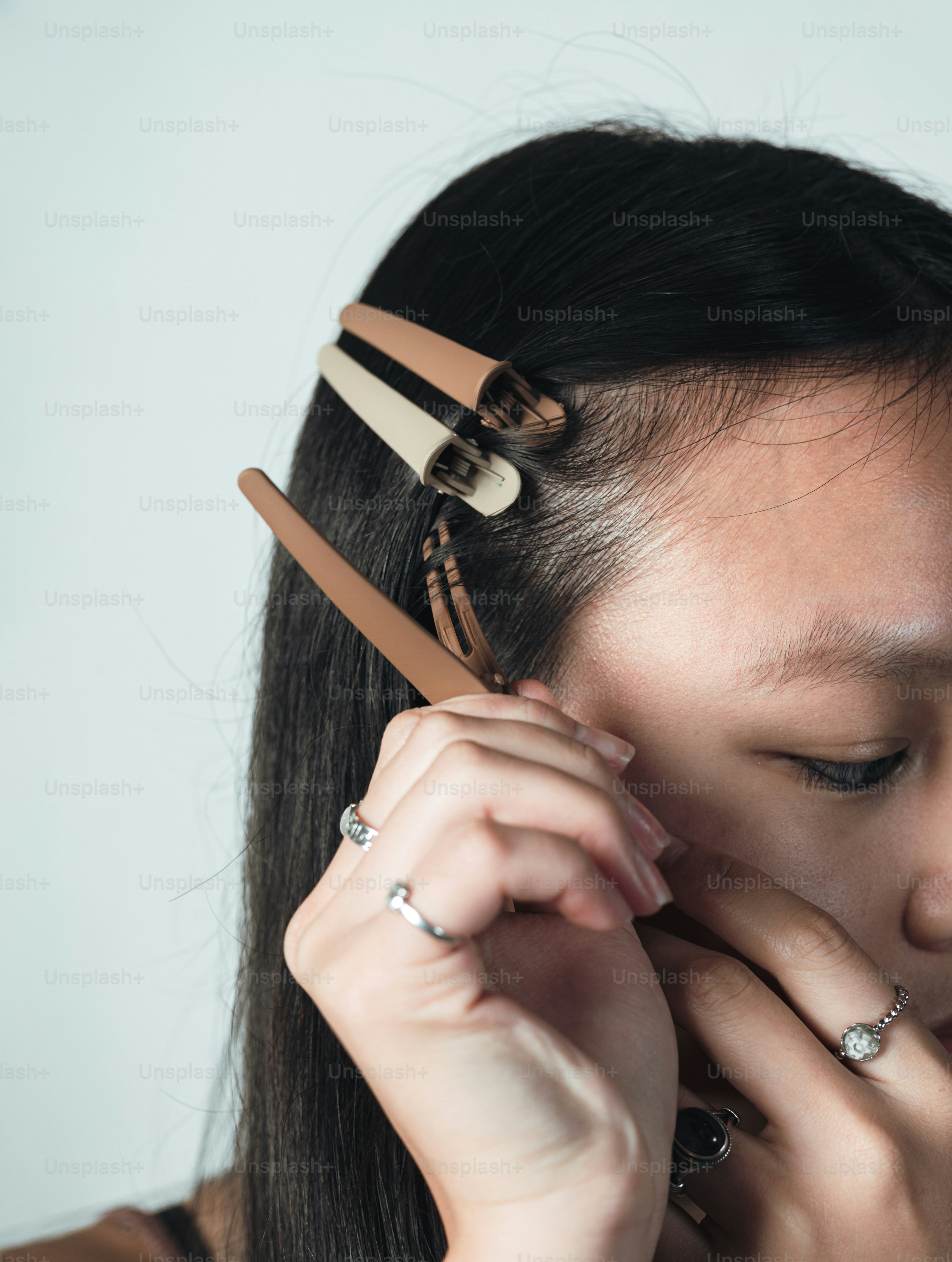 A woman with a pair of scissors in her hair