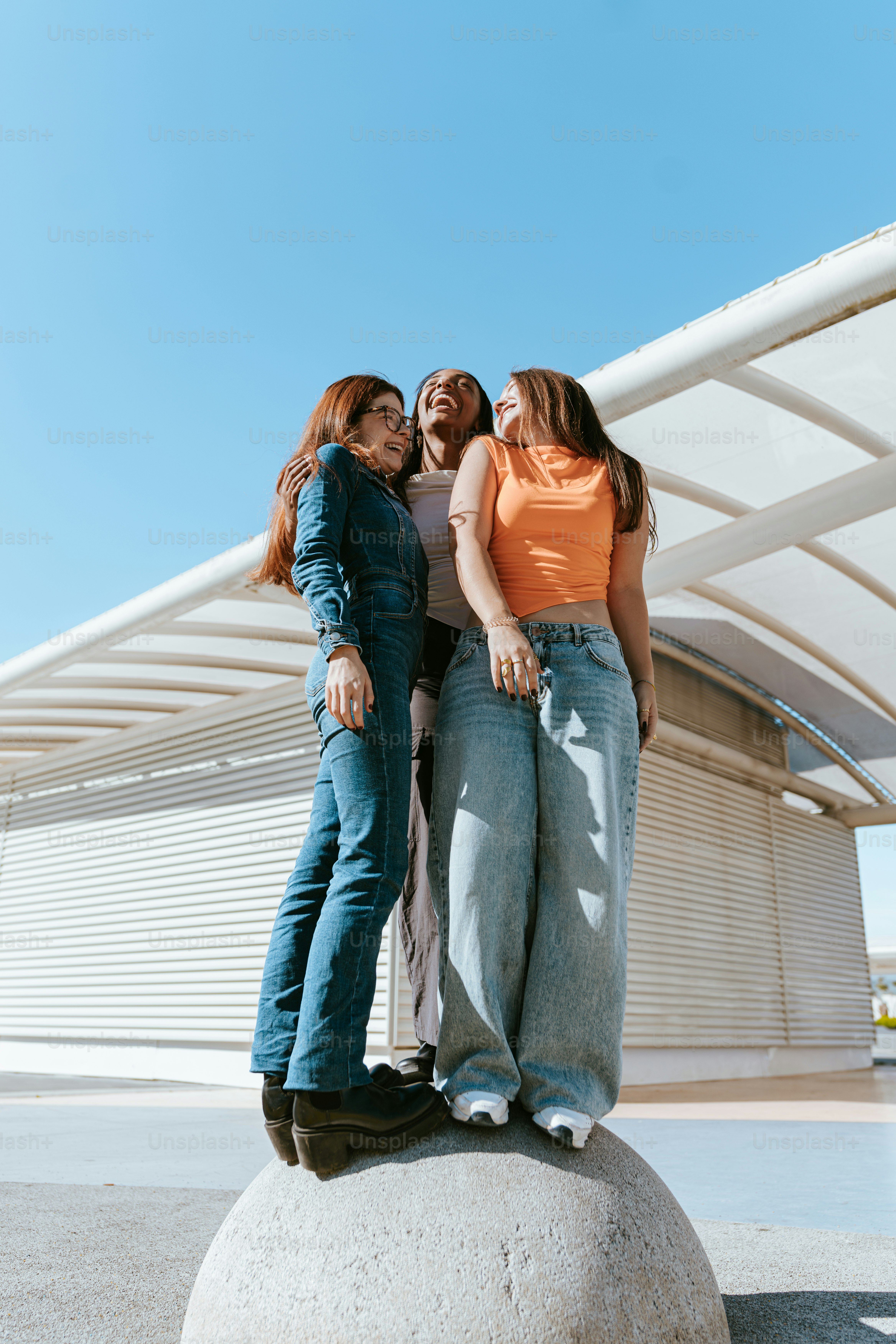 A group of three women standing next to each other photo – Gen z Image ...