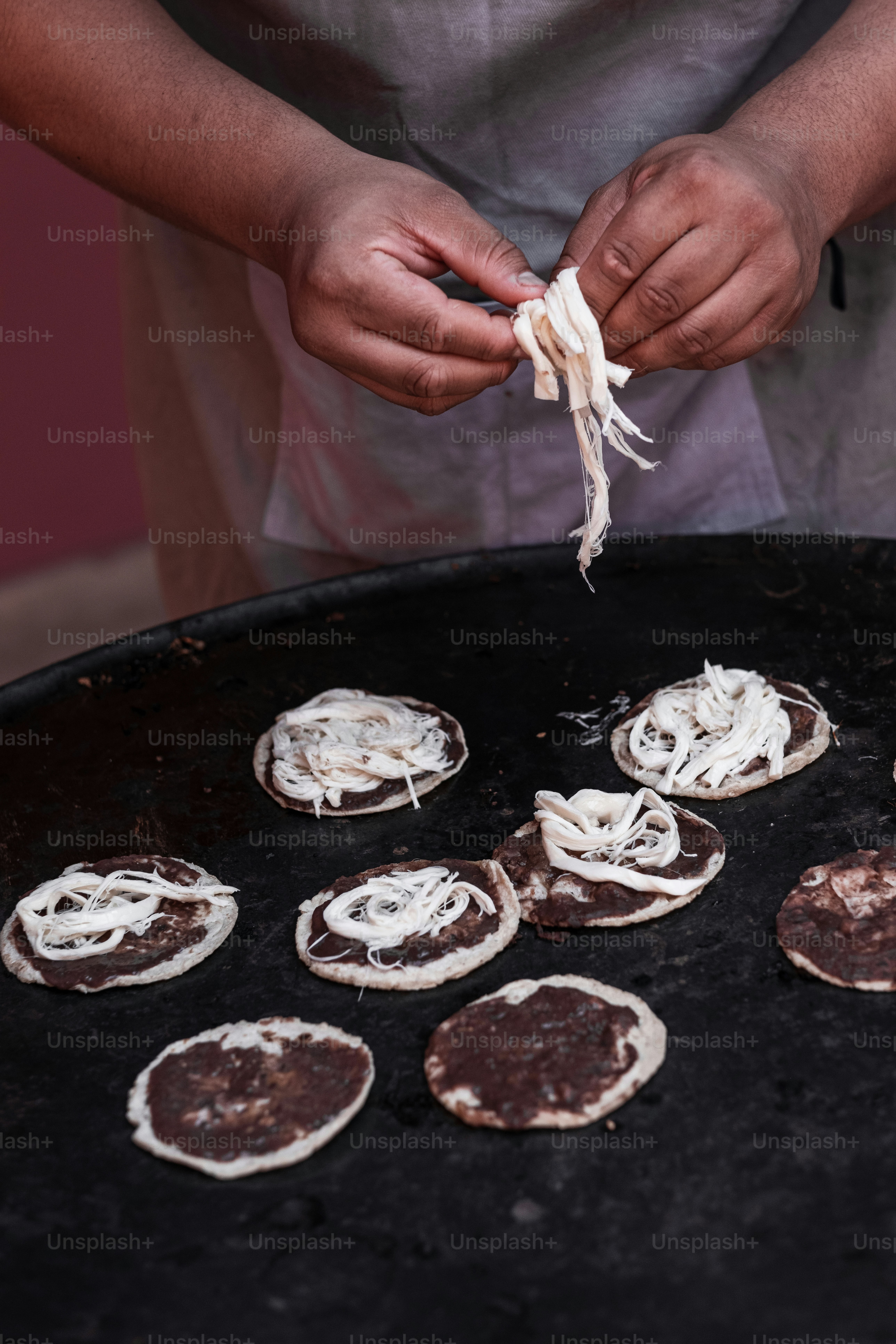 A person preparing food on top of a grill