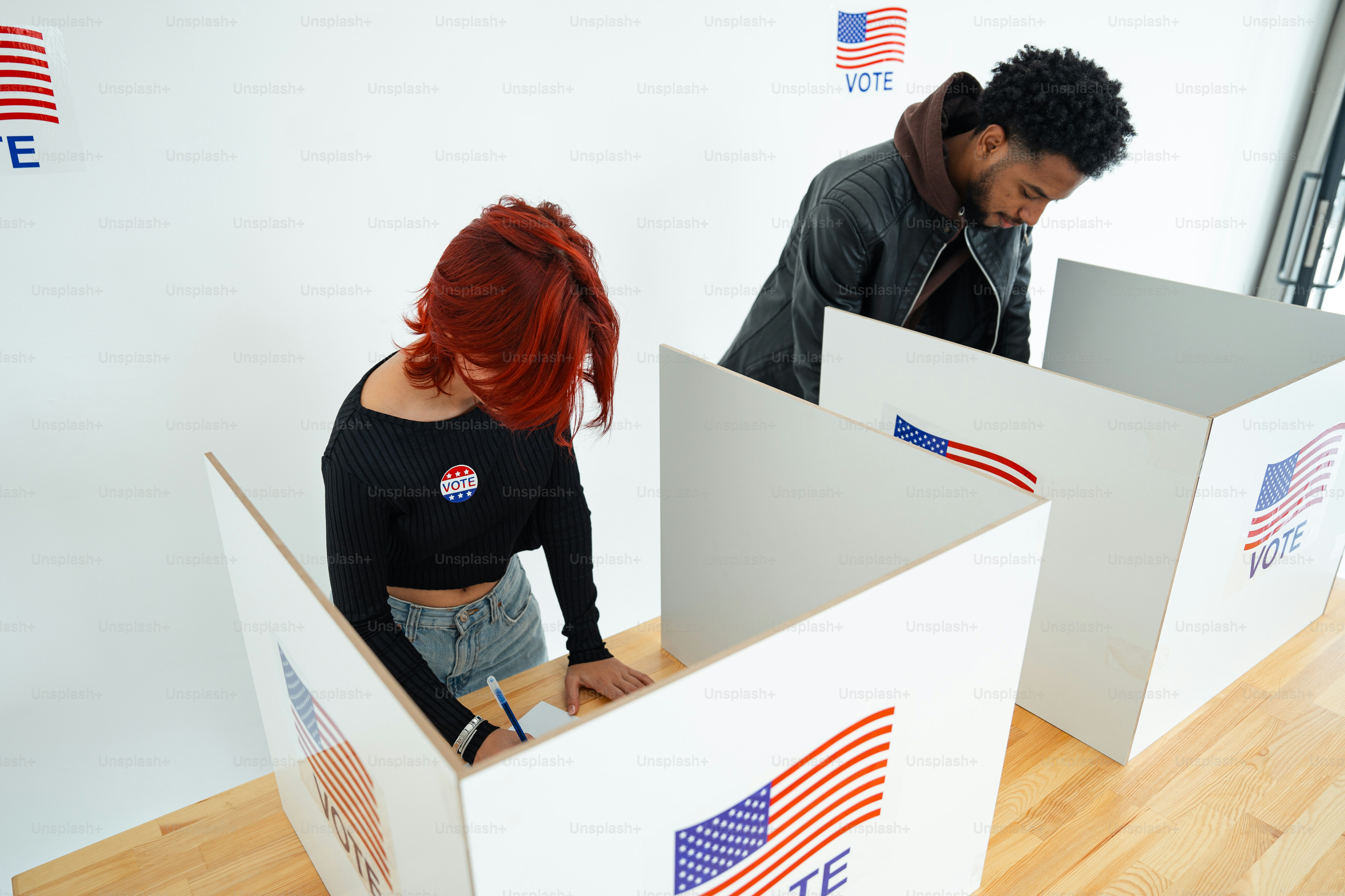 A man and a woman standing inside of boxes