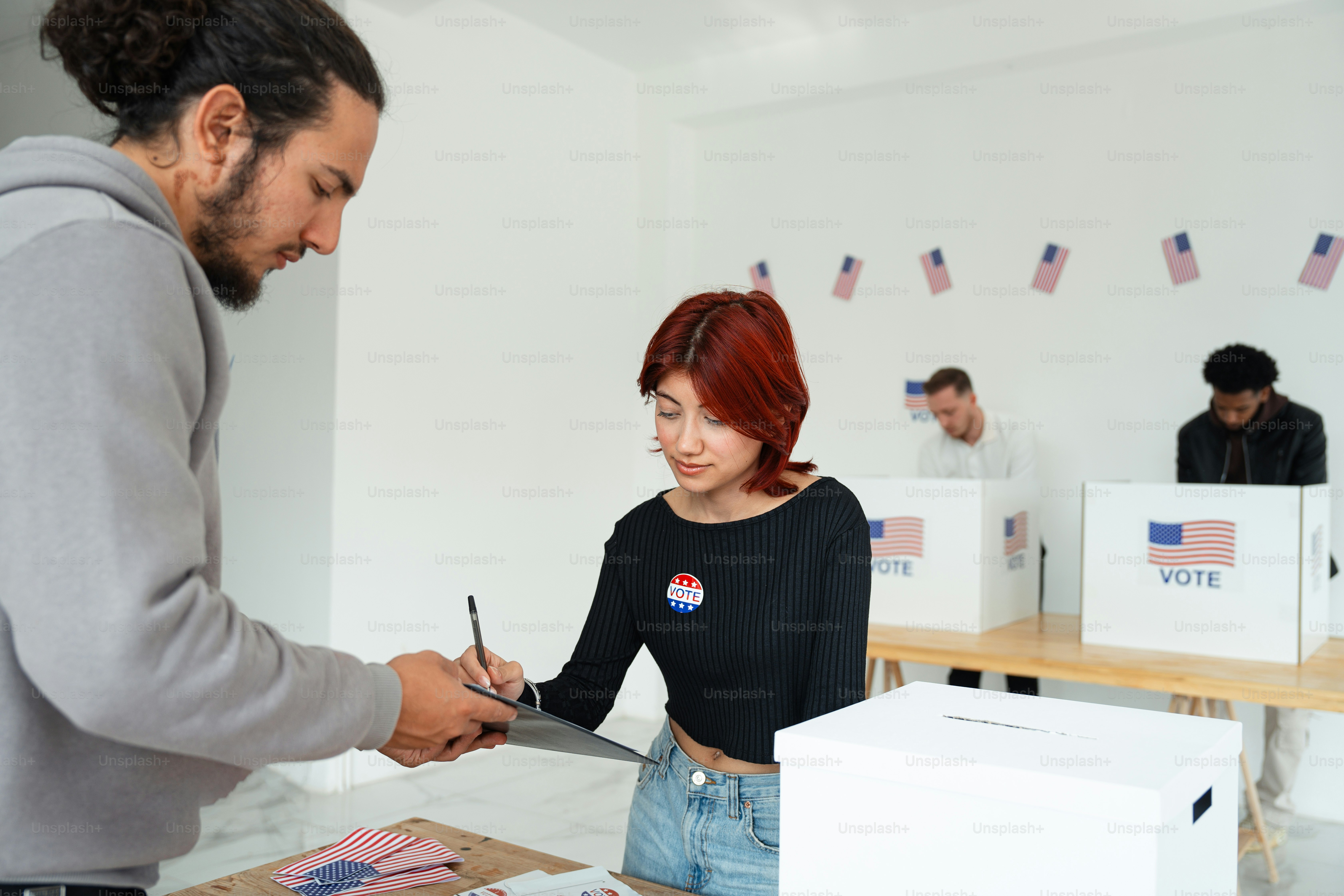 A man standing in front of a voting booth photo – American flag Image ...