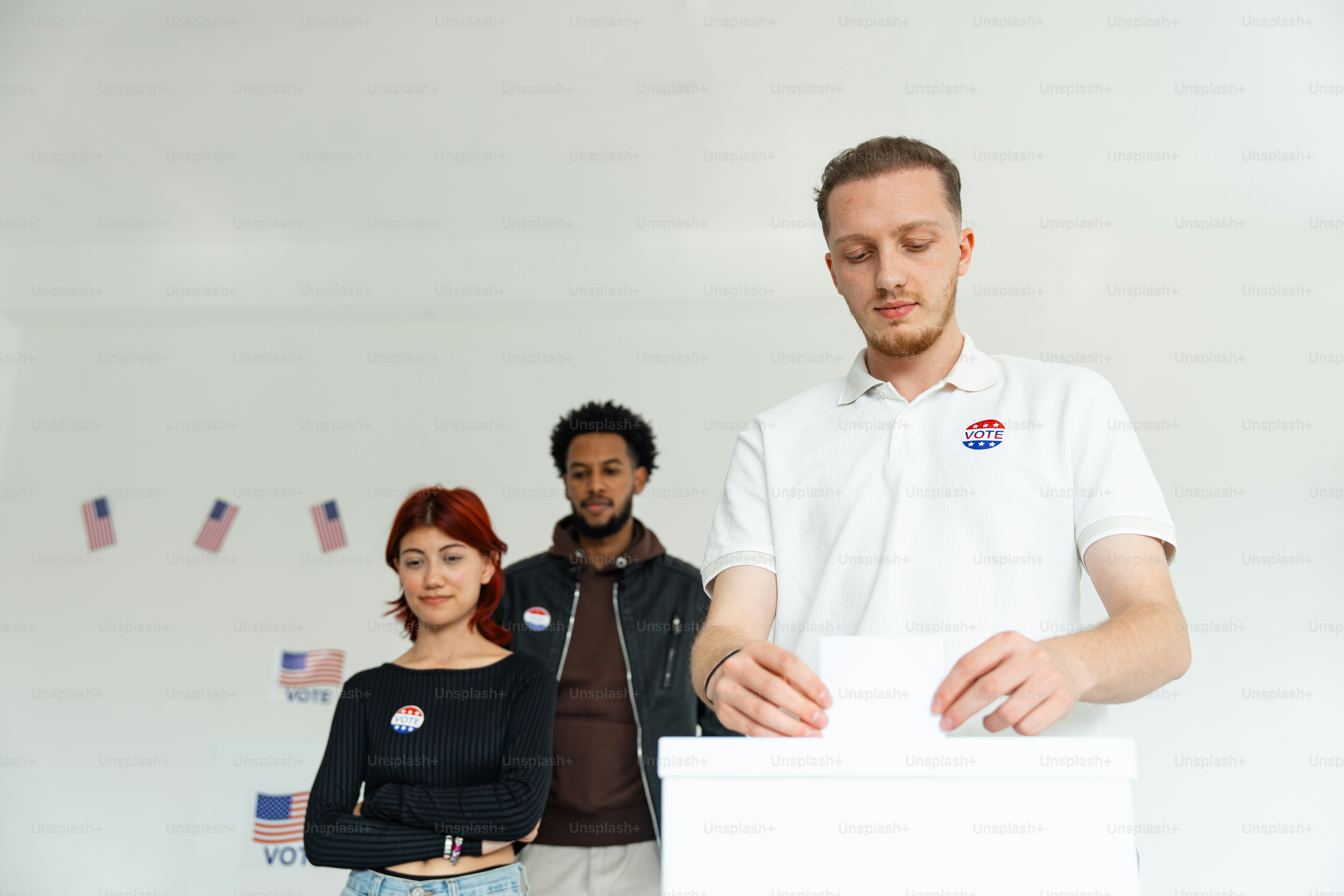 A group of people standing around a white board