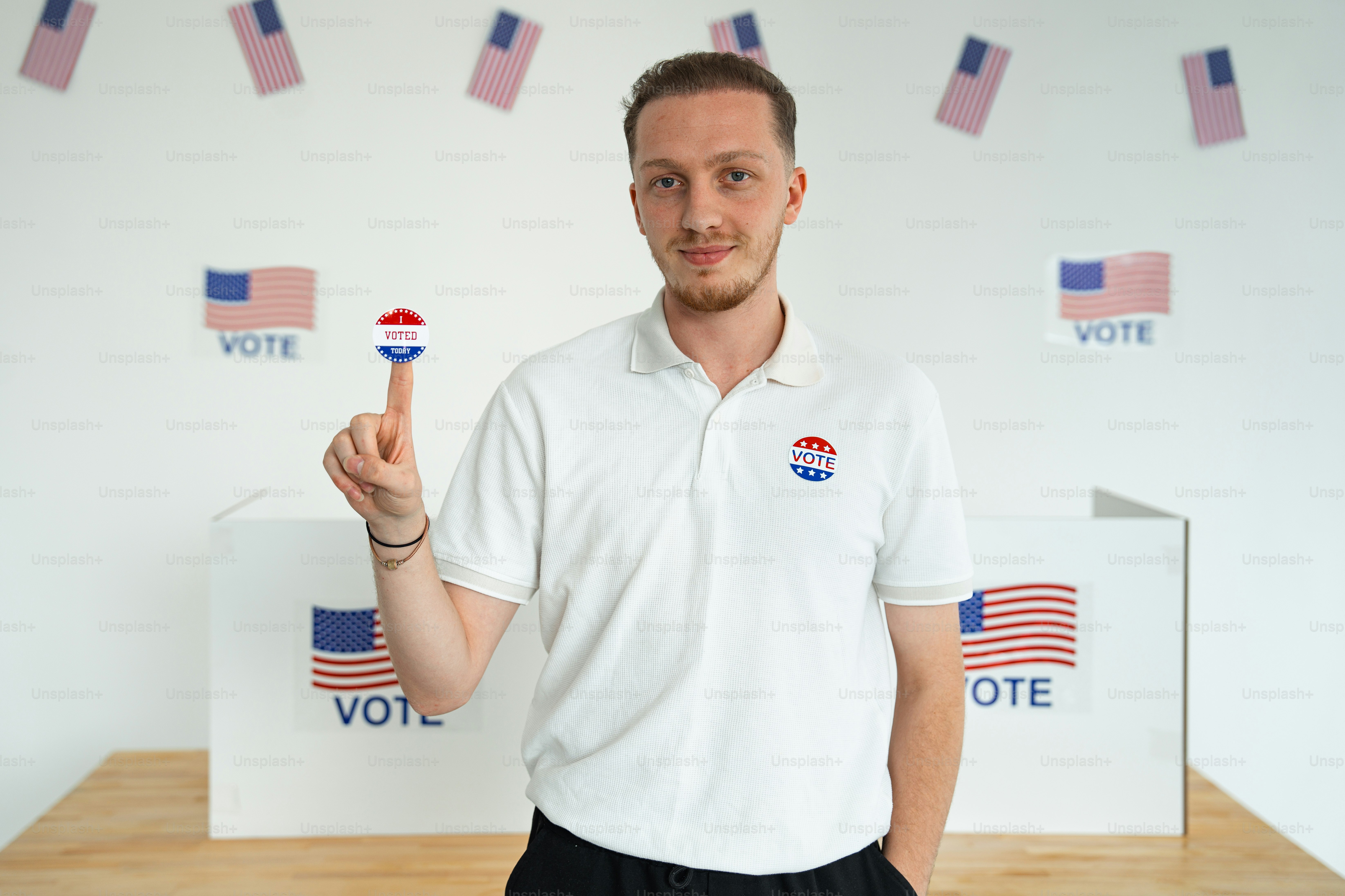 A man standing in front of a voting booth