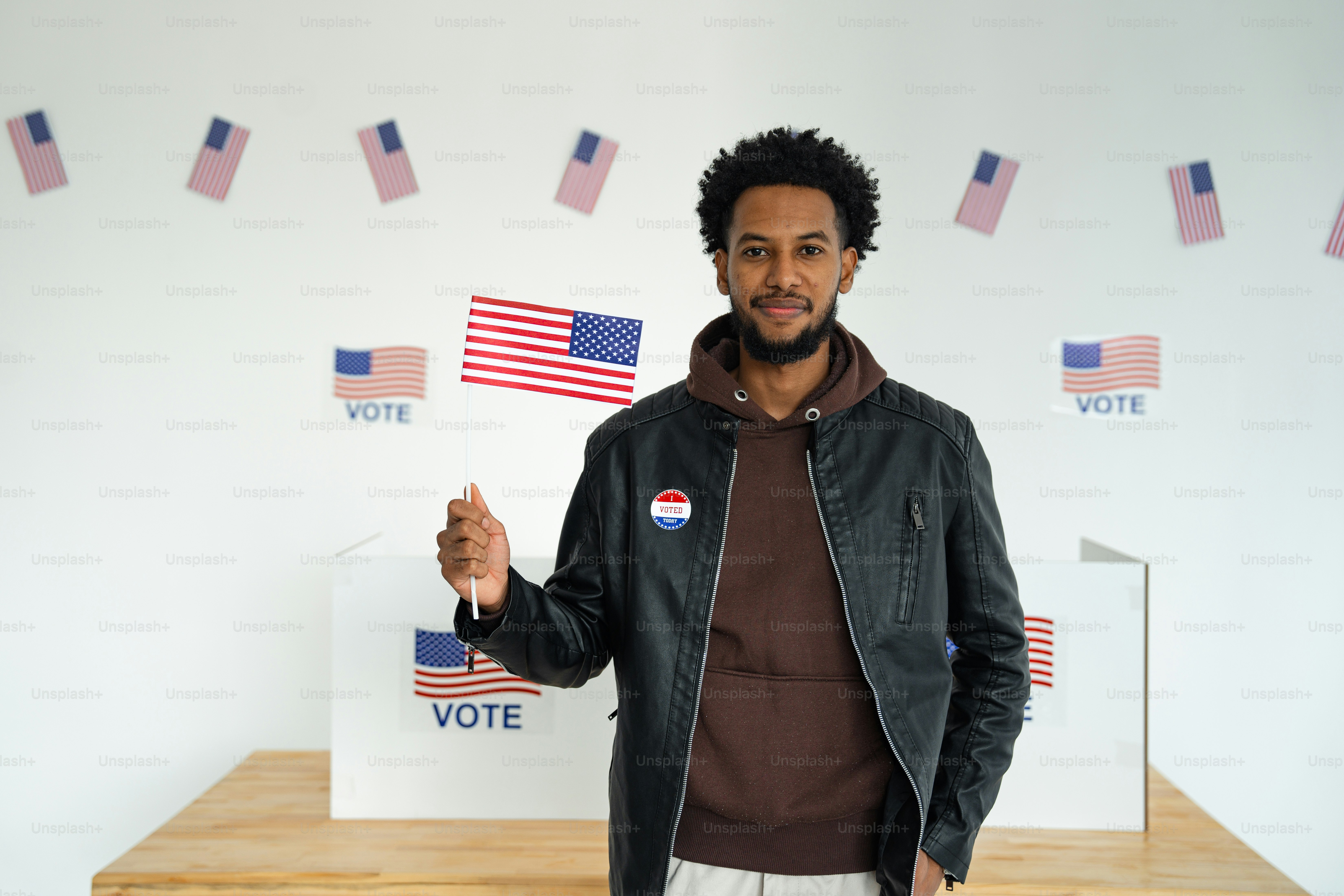 A man standing in front of a voting booth photo – Politics Image on ...