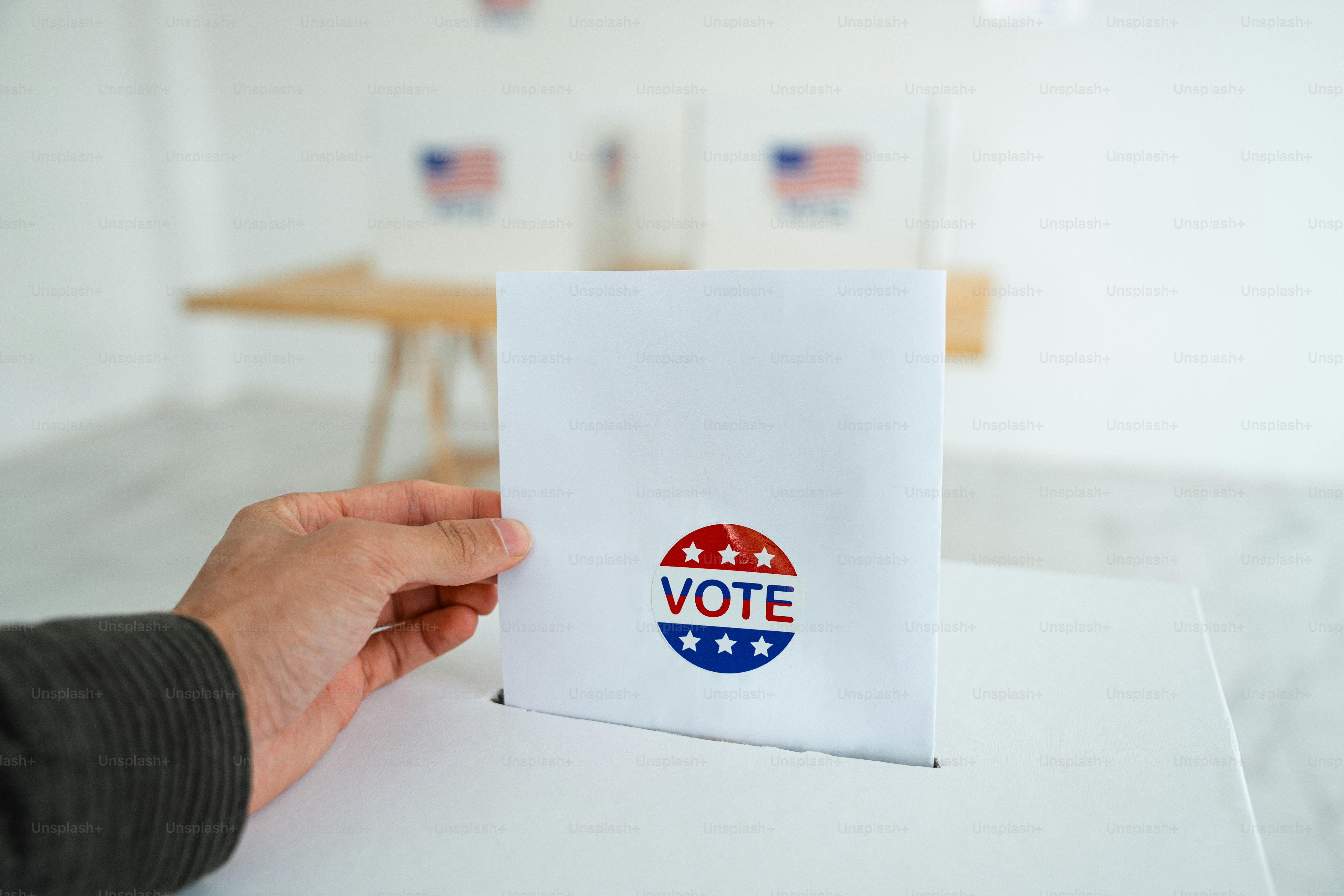 A person holding a voting paper with the word vote on it